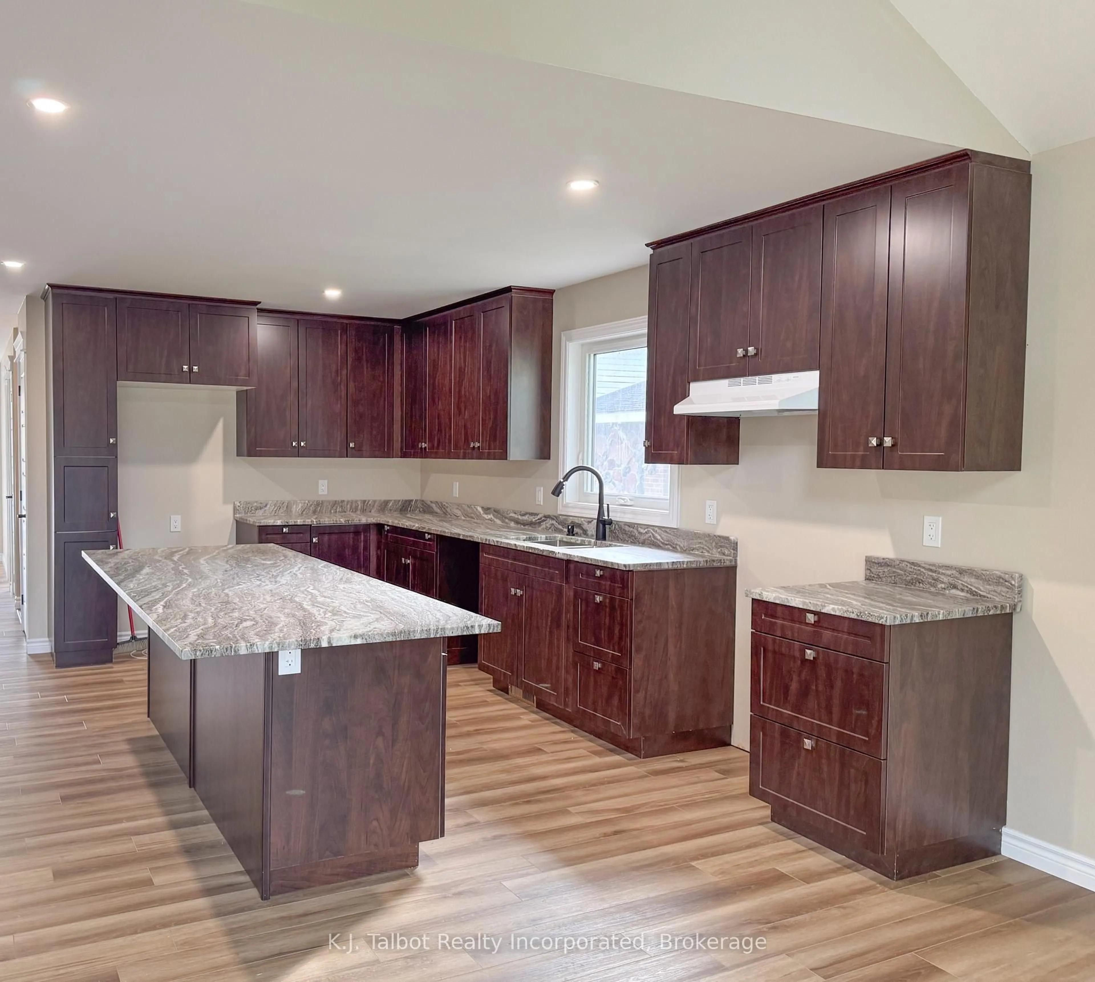 Open concept kitchen, wood/laminate floor for 52 Queen St, Huron East Ontario N0G 1H0