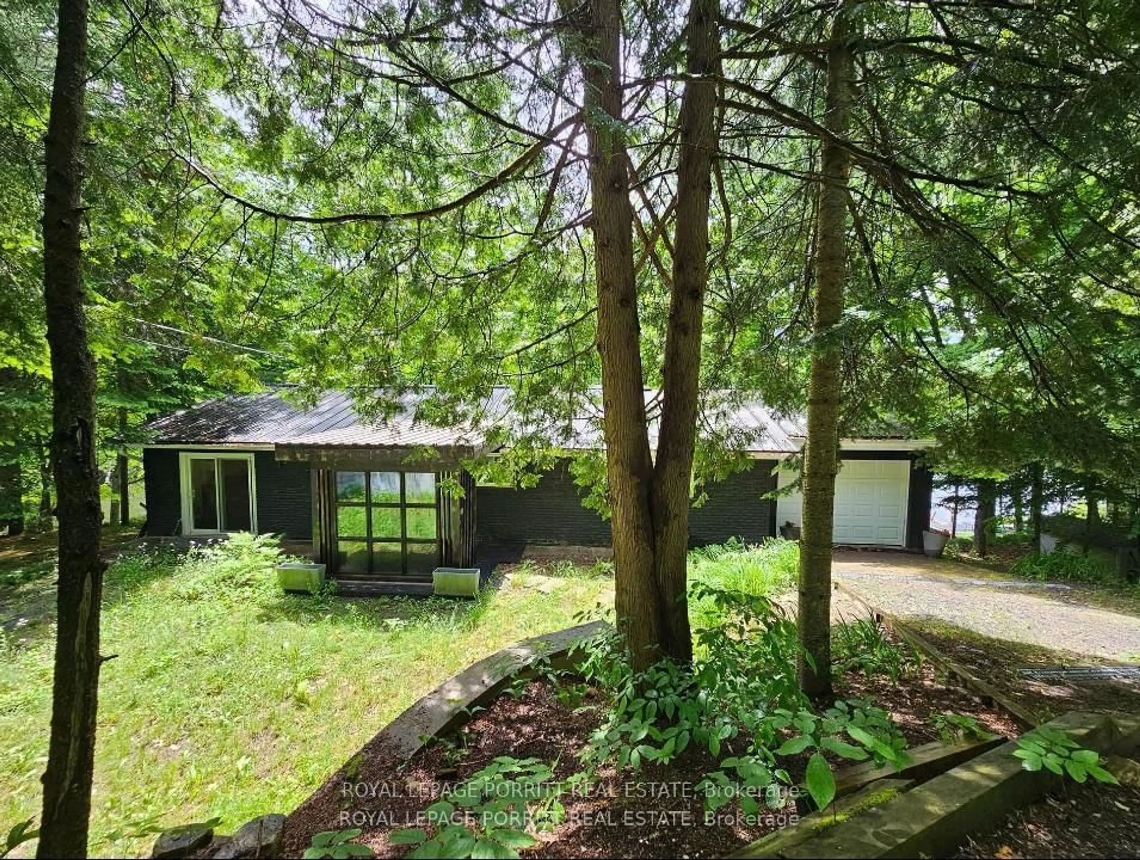 A pic from outside/outdoor area/front of a property/back of a property/a pic from drone, forest/trees view for 1015 Bayview Point Rd, Lake of Bays Ontario P0A 1H0