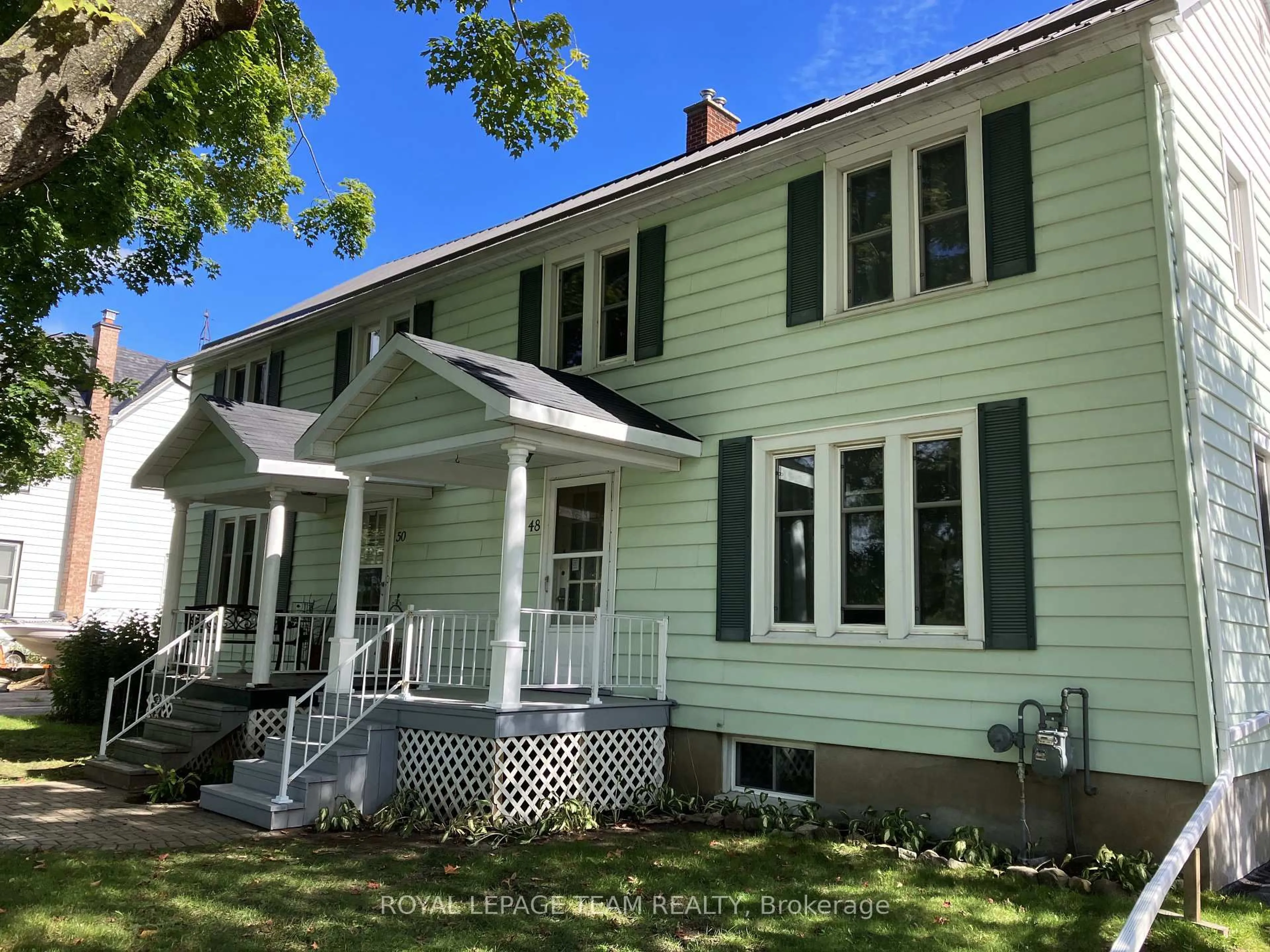 Home with vinyl exterior material, street for 48-50 Beach St, South Dundas Ontario K0E 1K0