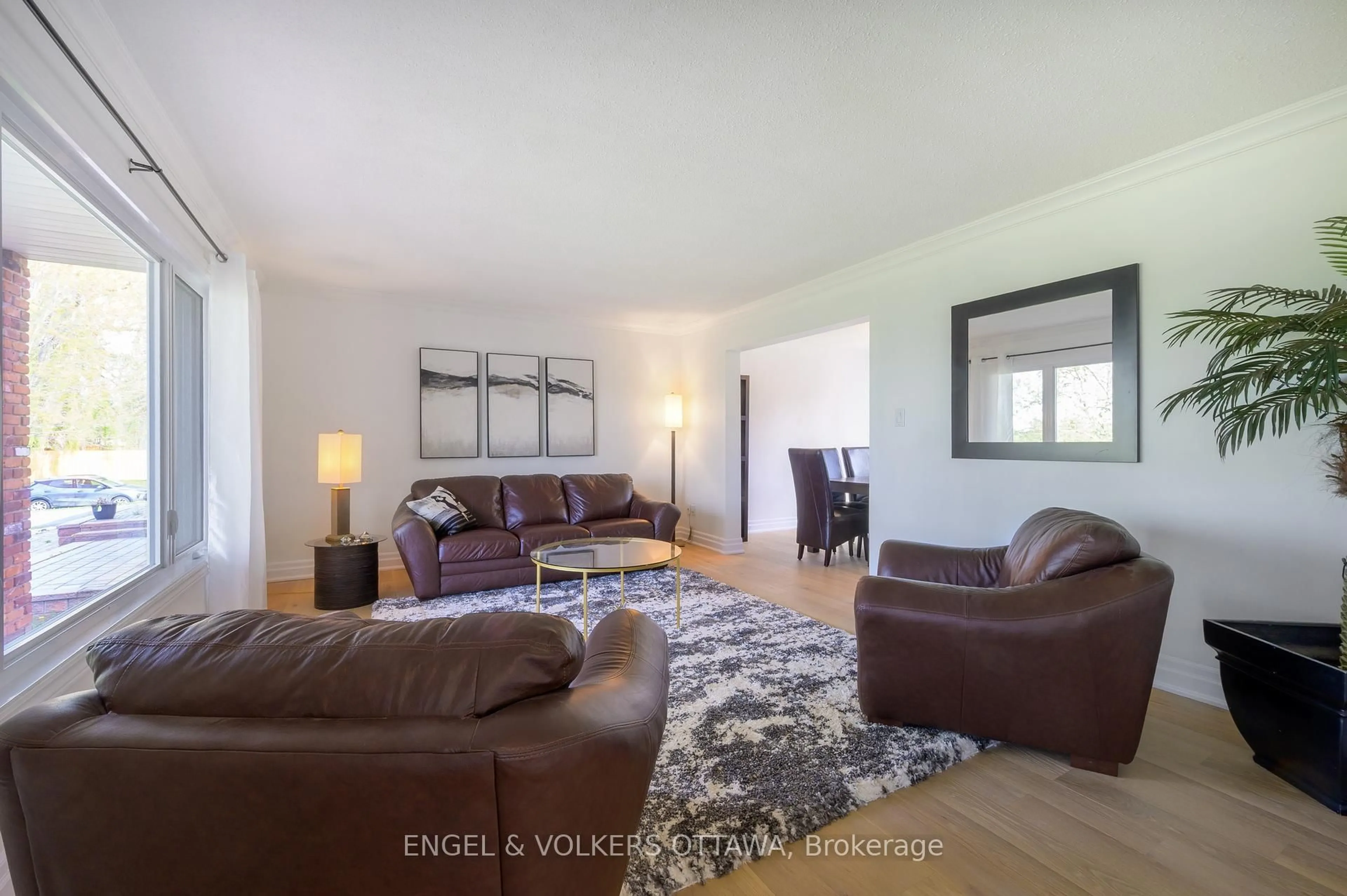 Living room with furniture, wood/laminate floor for 5608 Richmond Rd, Ottawa Ontario K2R 1E3