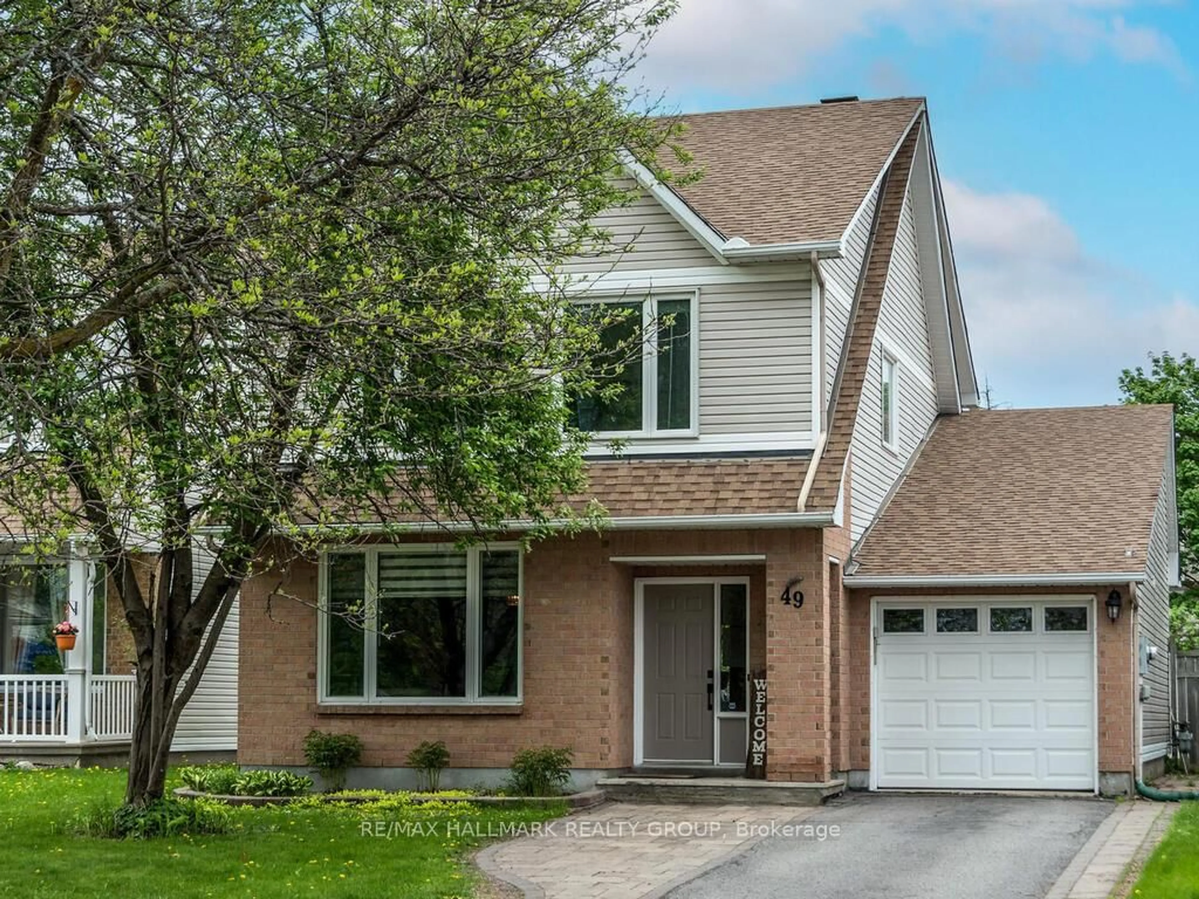 Home with vinyl exterior material, street for 49 Grassy Plains Dr, Ottawa Ontario K2M 2L6