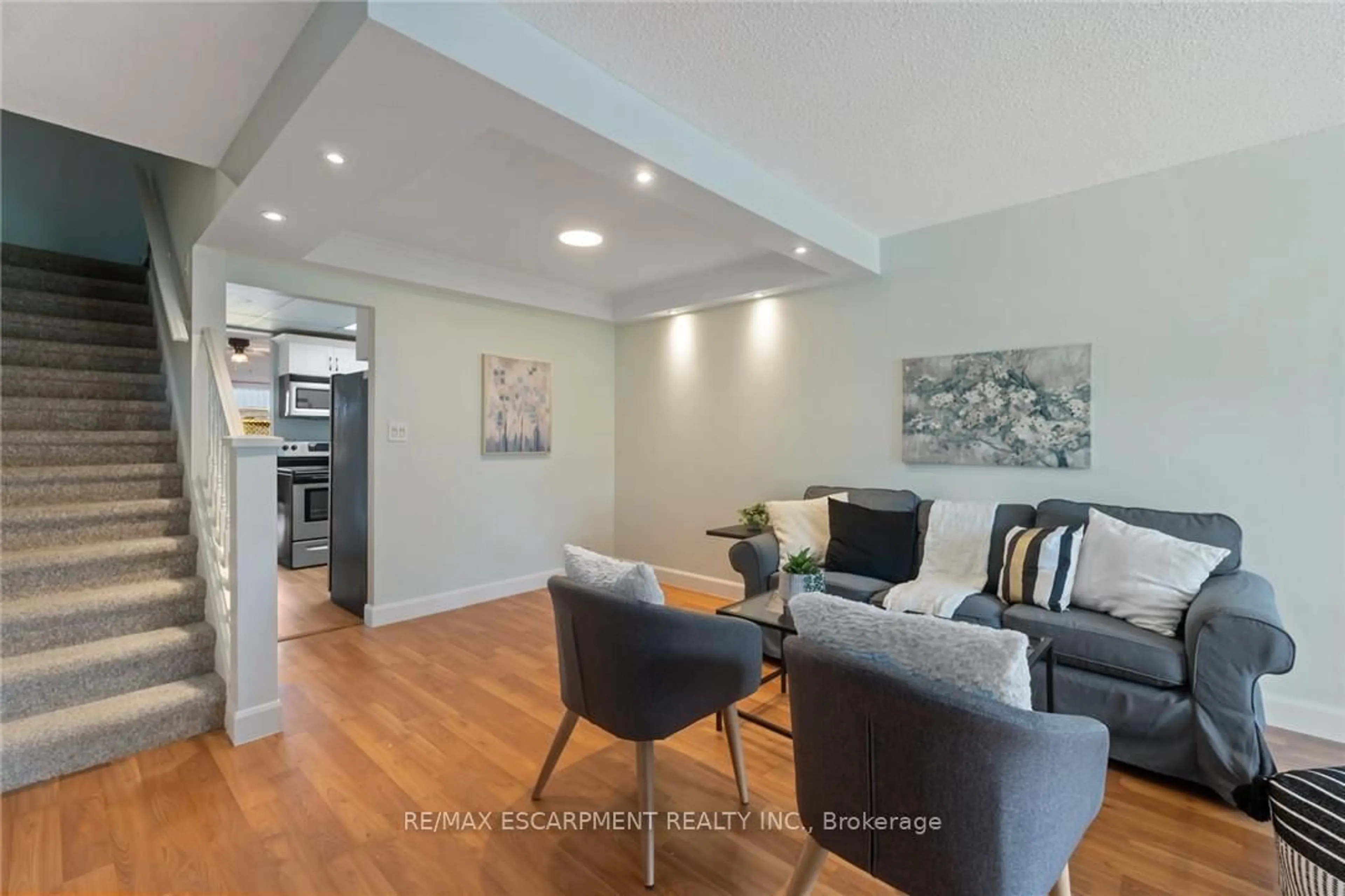 Living room with furniture, wood/laminate floor for 8646 WILLOUGHBY Dr #10, Niagara Falls Ontario L2G 6X7