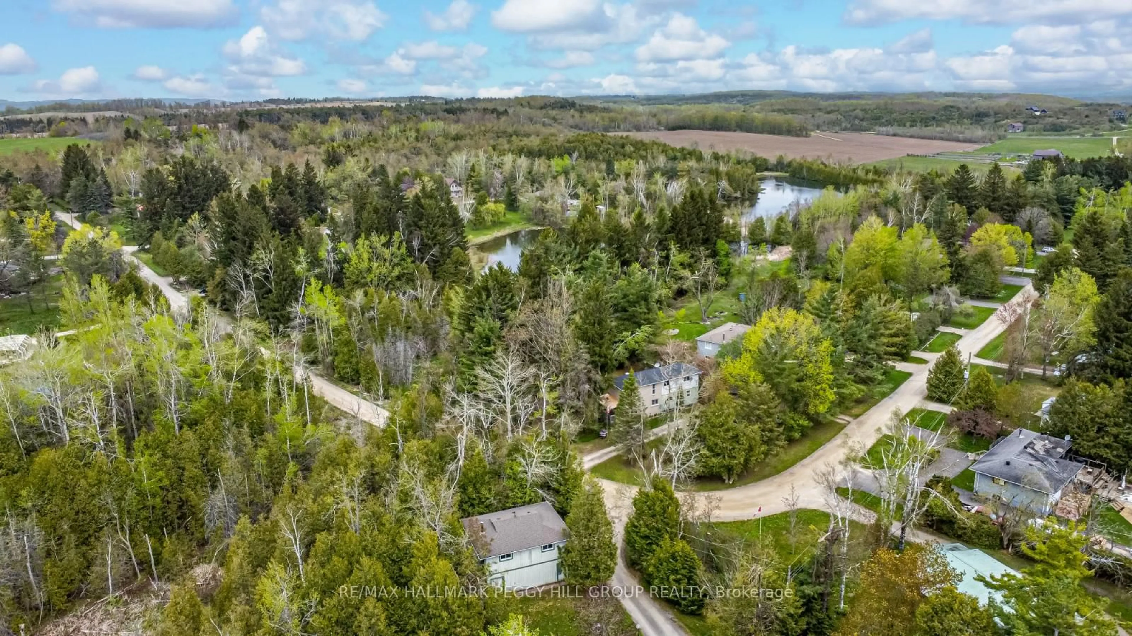 A pic from outside/outdoor area/front of a property/back of a property/a pic from drone, forest/trees view for 6 McCutcheon Rd, Mulmur Ontario L9V 3E8