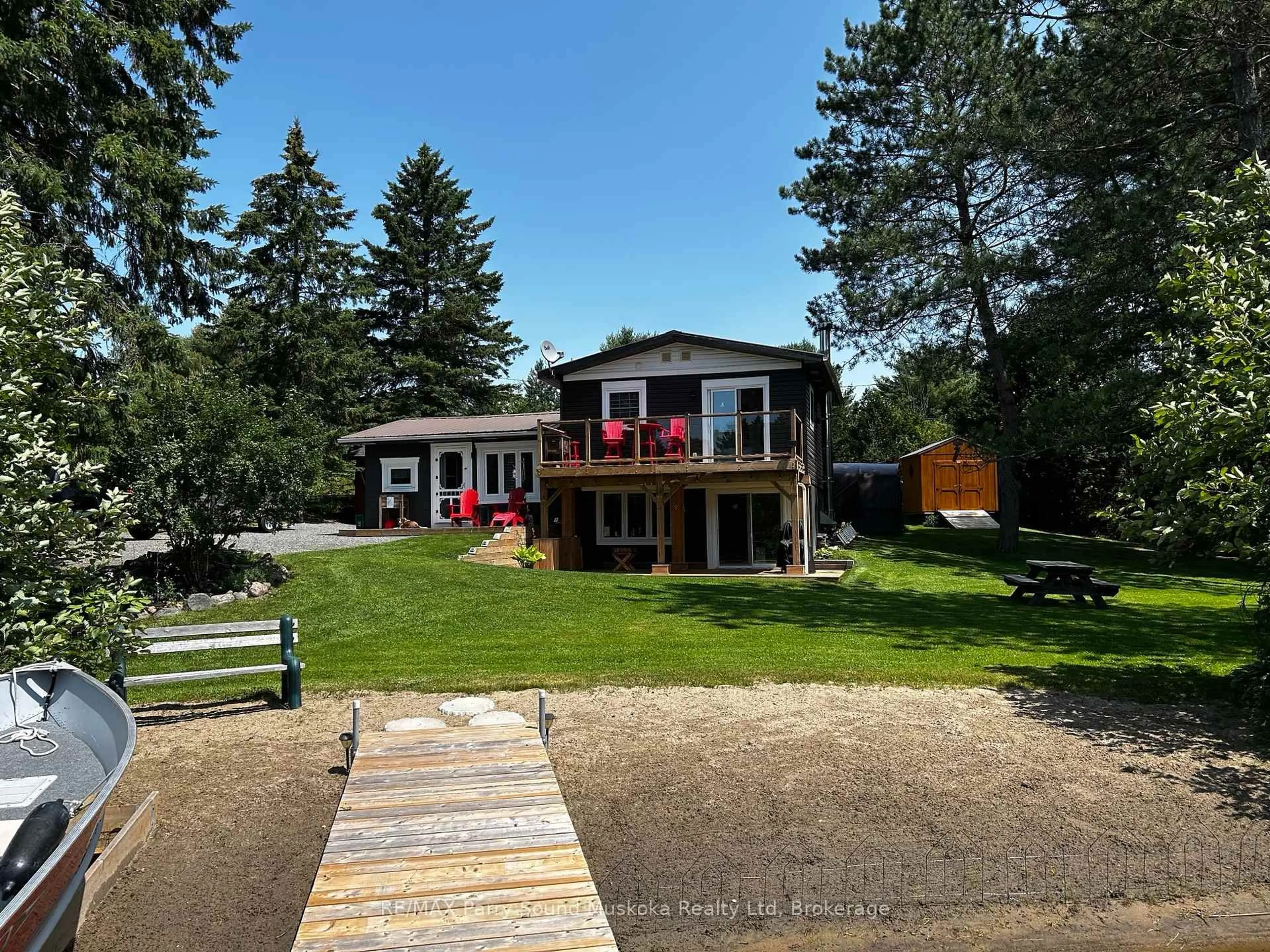 A pic from outside/outdoor area/front of a property/back of a property/a pic from drone, water/lake/river/ocean view for 22 Dickinson Rd, McKellar Ontario P2A 2W7