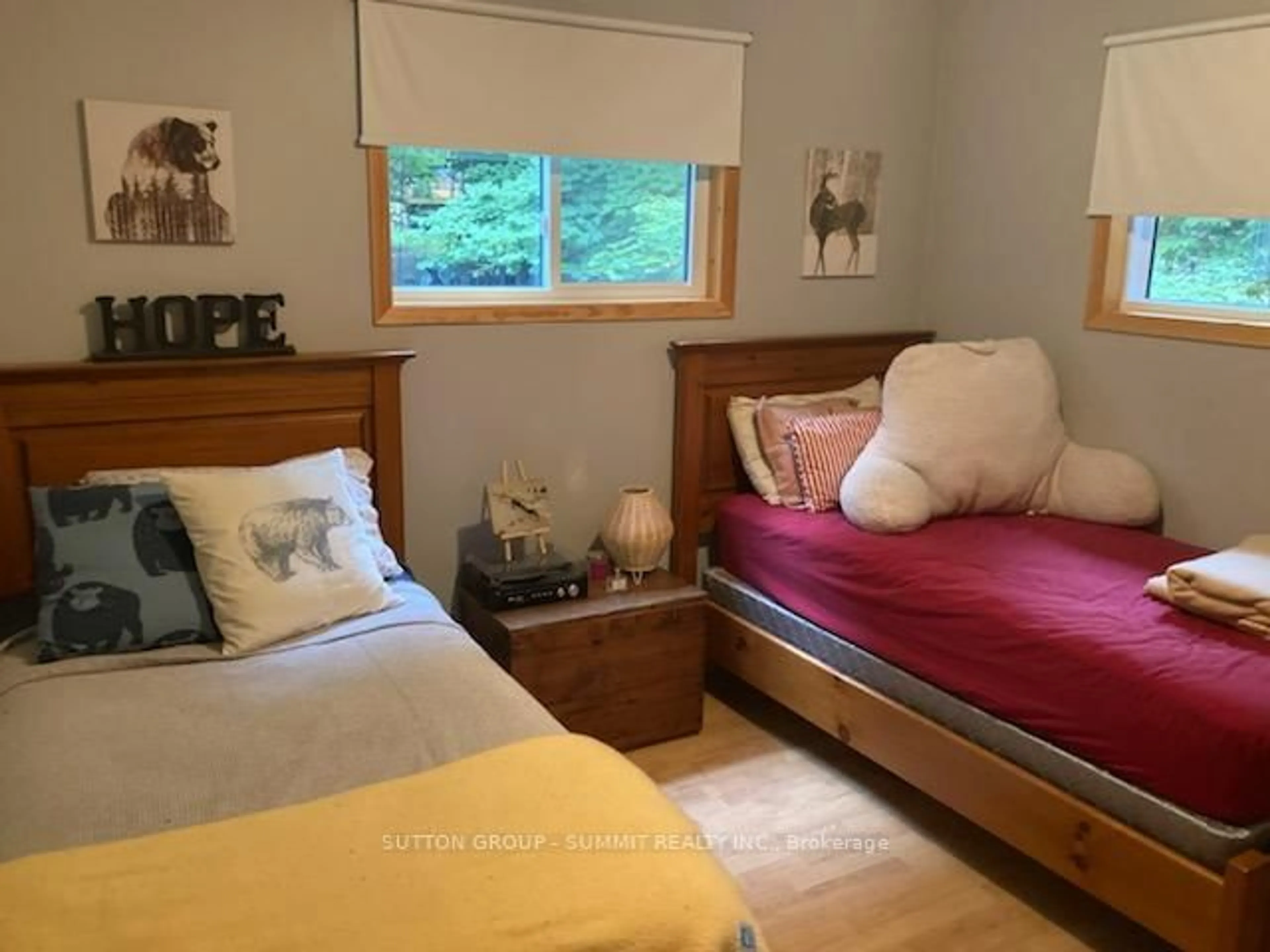 Bedroom with bed, wood/laminate floor for 119 HOOD Rd, Huntsville Ontario P1H 2J3