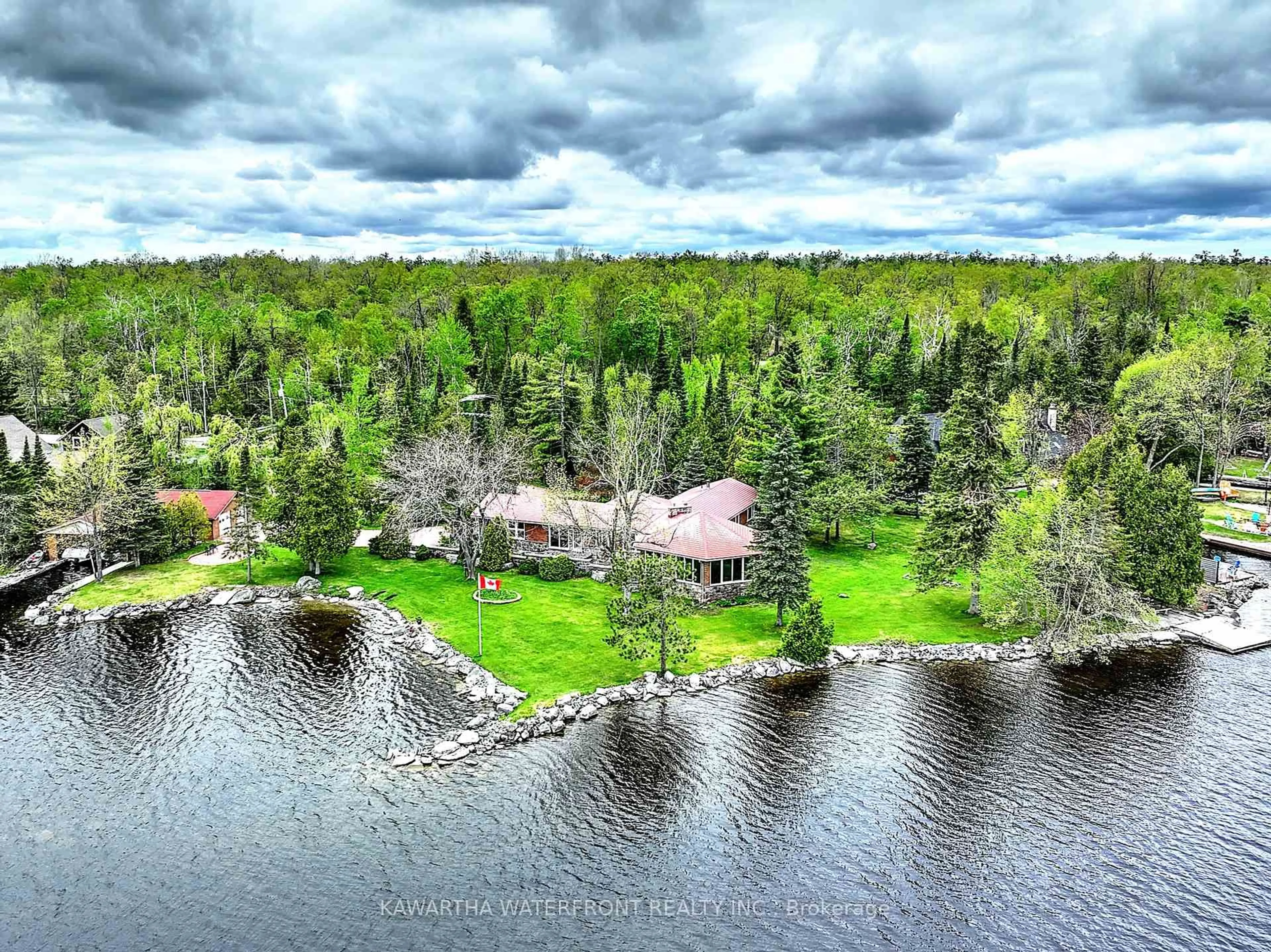 A pic from outside/outdoor area/front of a property/back of a property/a pic from drone, water/lake/river/ocean view for 557 Riverside Dr, Trent Lakes Ontario K0M 1A0