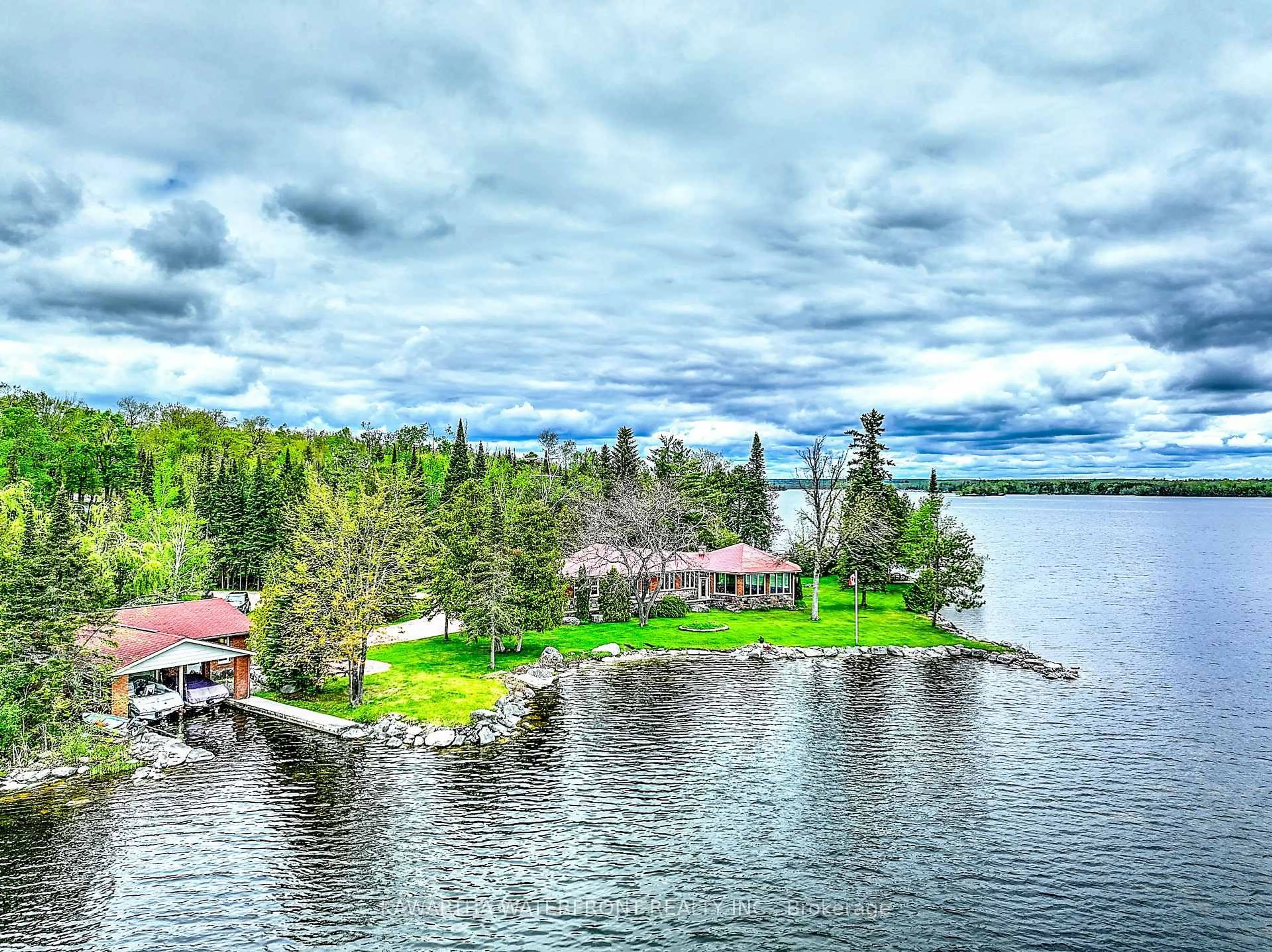A pic from outside/outdoor area/front of a property/back of a property/a pic from drone, water/lake/river/ocean view for 557 Riverside Dr, Trent Lakes Ontario K0M 1A0