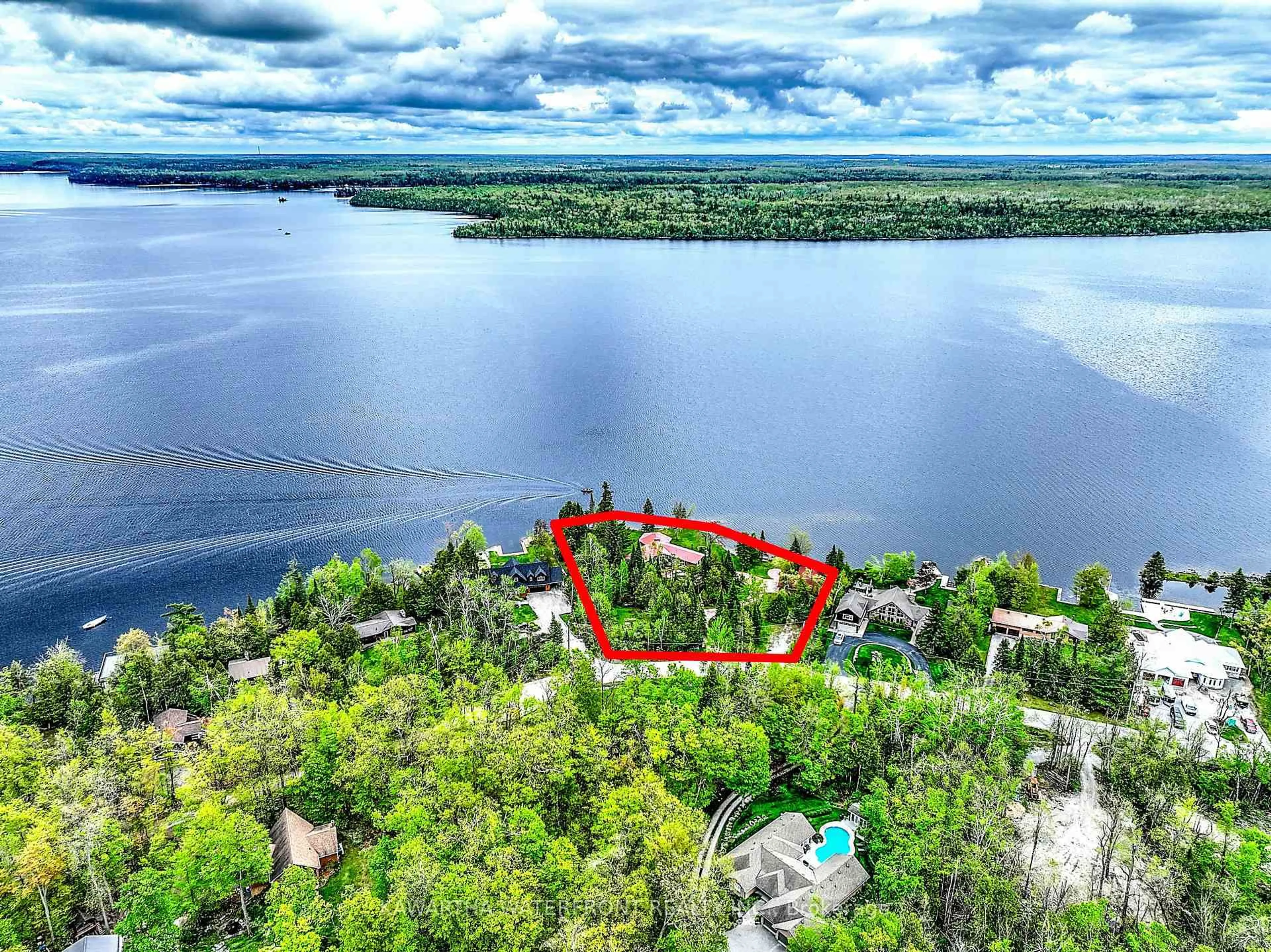 A pic from outside/outdoor area/front of a property/back of a property/a pic from drone, water/lake/river/ocean view for 557 Riverside Dr, Trent Lakes Ontario K0M 1A0