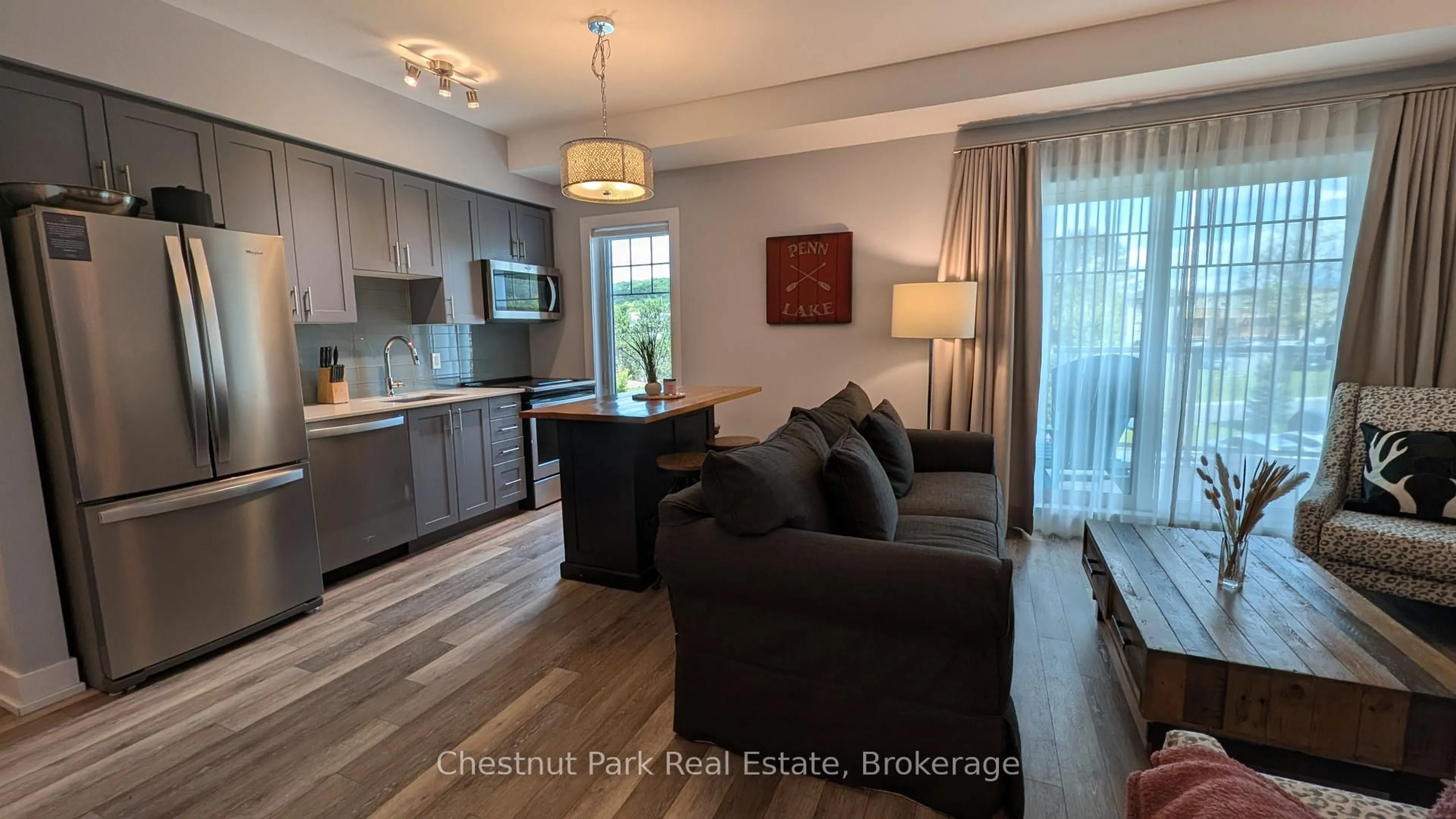 Living room with furniture, wood/laminate floor for 25 PEN LAKE POINT Rd #316, Huntsville Ontario P1H 1A9