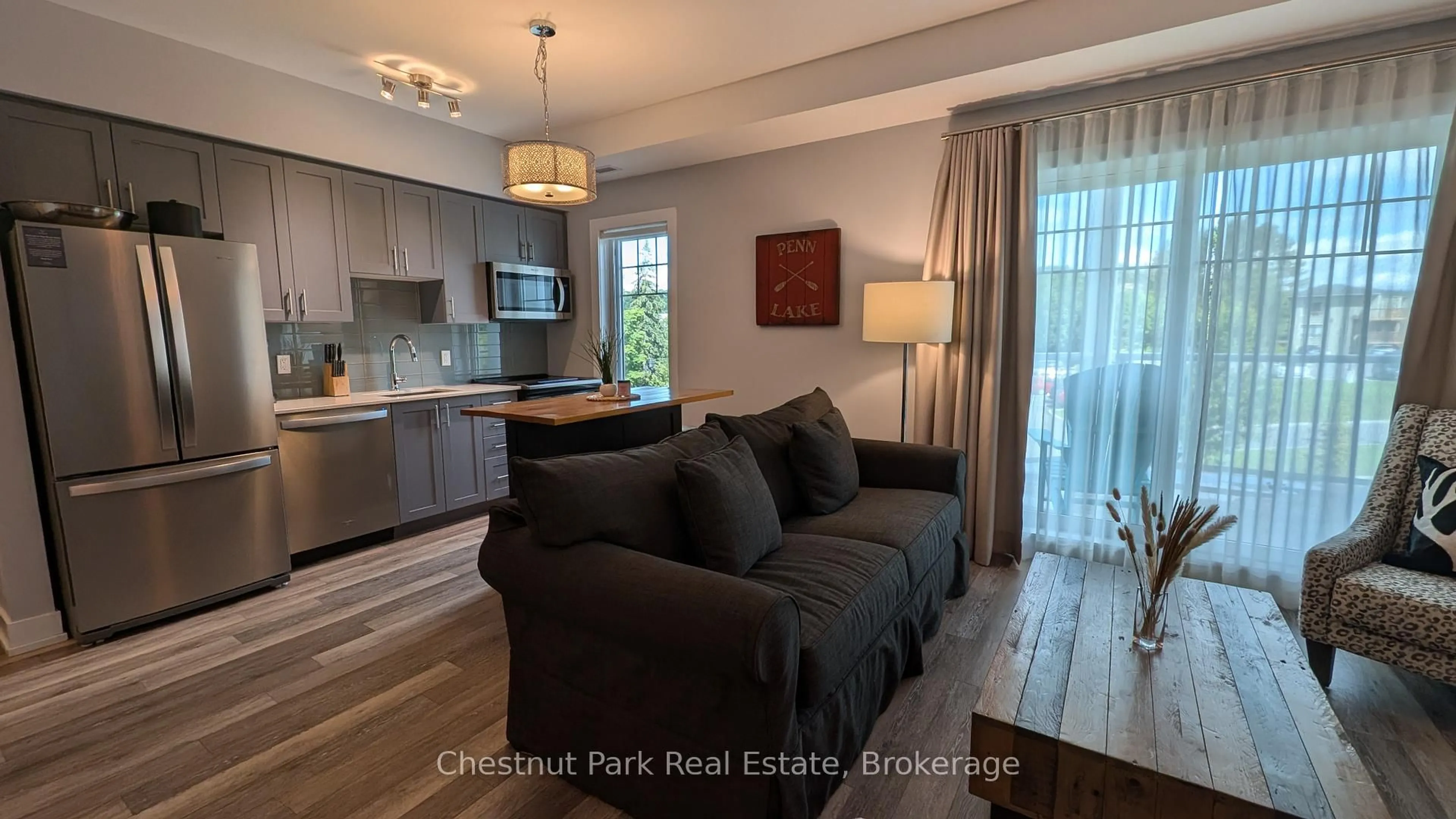 Living room with furniture, wood/laminate floor for 25 PEN LAKE POINT Rd #316, Huntsville Ontario P1H 1A9