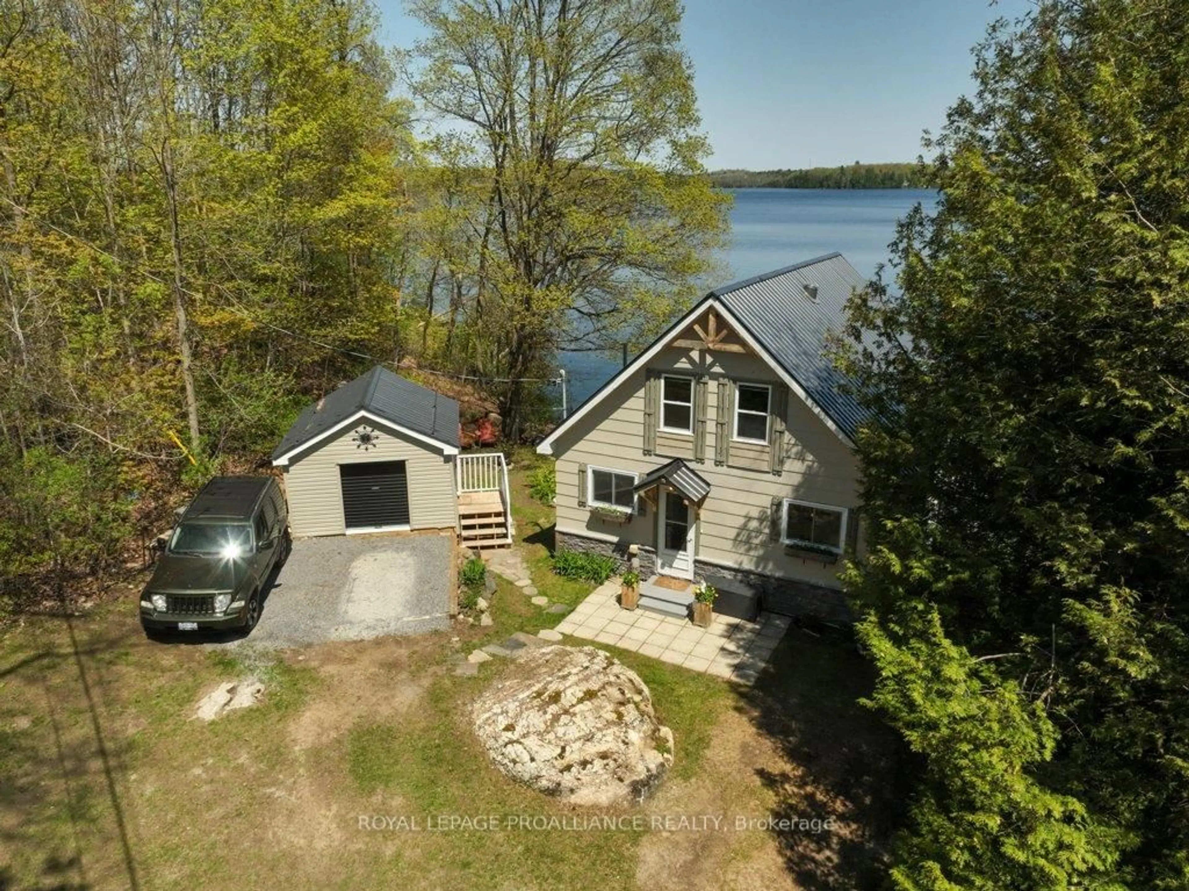 A pic from outside/outdoor area/front of a property/back of a property/a pic from drone, water/lake/river/ocean view for 1043 D Big Clear Lane, Arden Ontario K0H 1B0