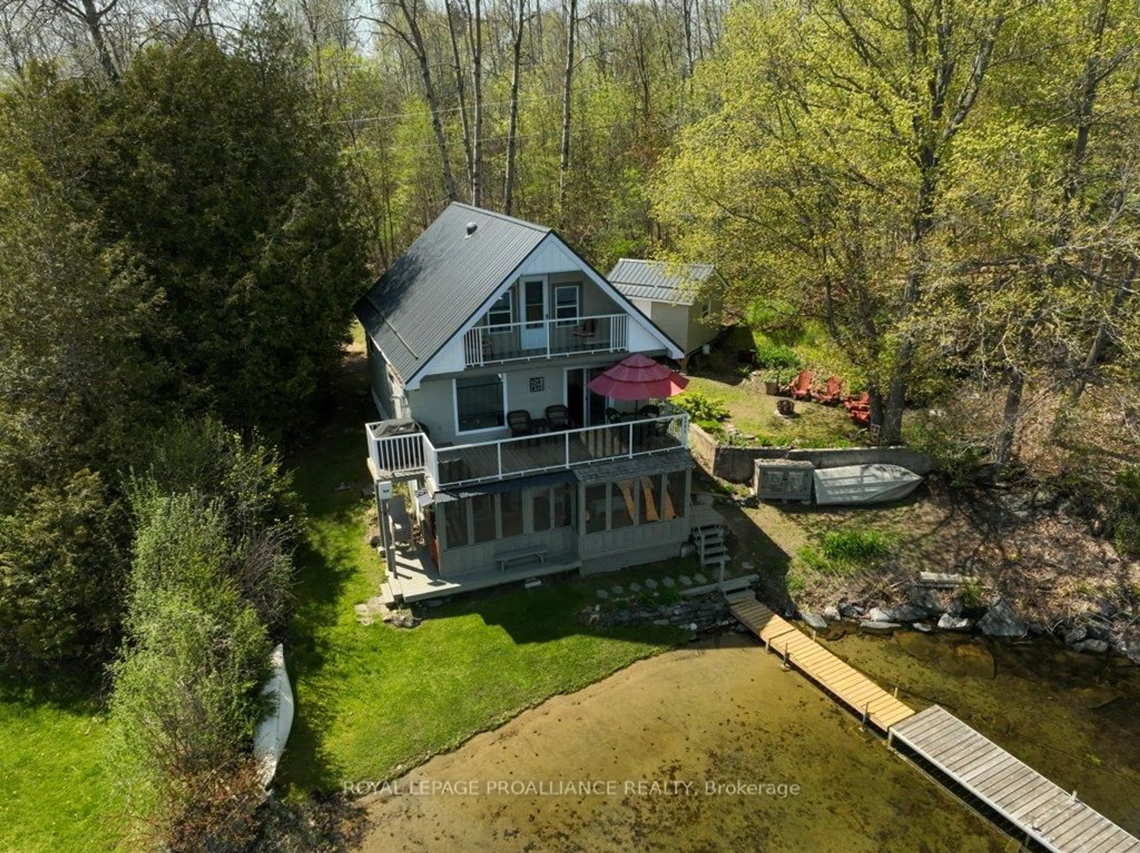 A pic from outside/outdoor area/front of a property/back of a property/a pic from drone, water/lake/river/ocean view for 1043 D Big Clear Lane, Arden Ontario K0H 1B0