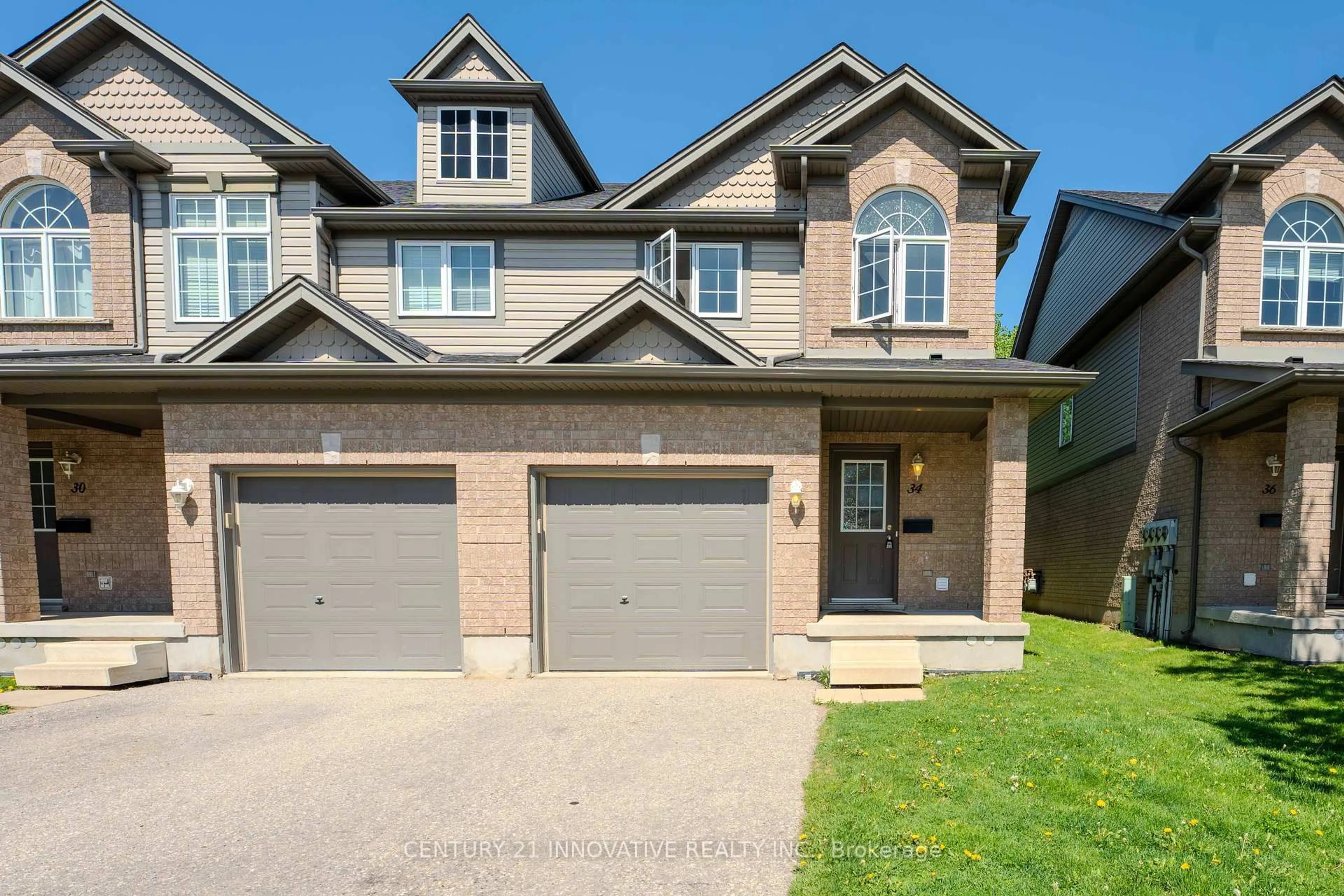 Home with brick exterior material, street for 34 Revell Dr, Guelph Ontario N1G 0B8