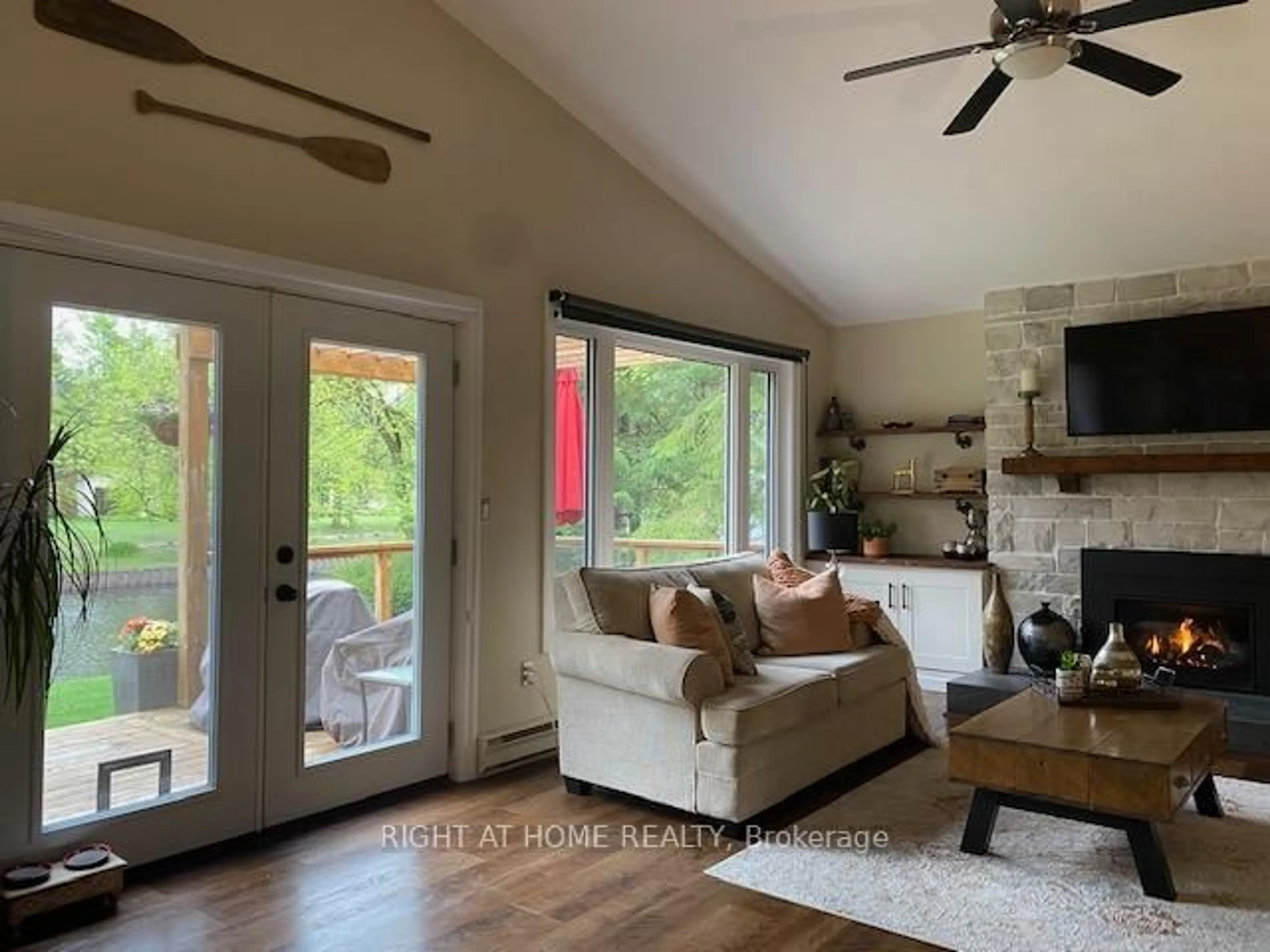 Living room with furniture, wood/laminate floor for 54 Riverbank Rd, Kawartha Lakes Ontario K0M 1N0