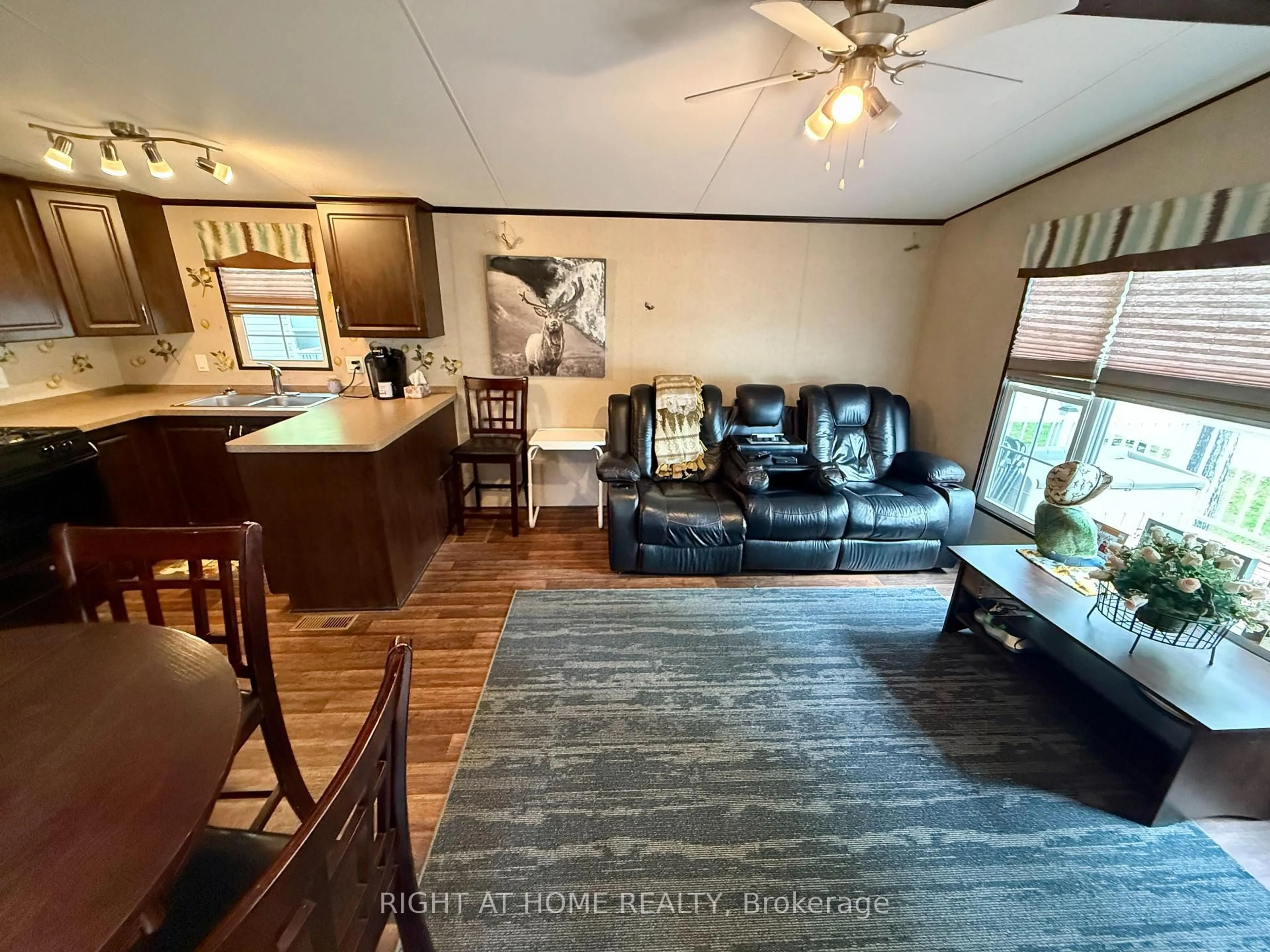 Living room with furniture, wood/laminate floor for 1082 Shamrock Marina Rd #63, Gravenhurst Ontario P0E 1N0