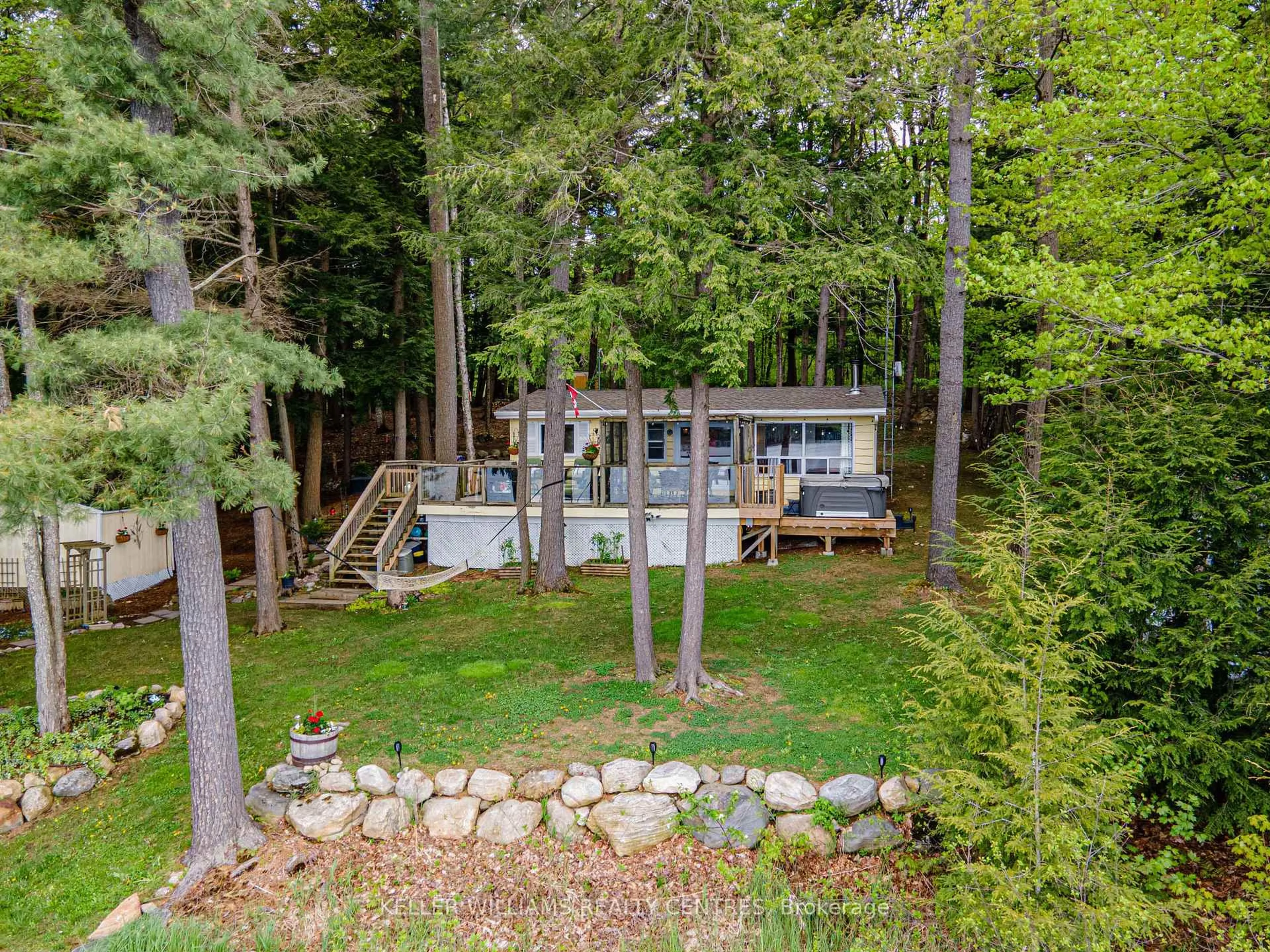 A pic from outside/outdoor area/front of a property/back of a property/a pic from drone, forest/trees view for 1019 Carl's Rd #5, Muskoka Lakes Ontario P0B 1J0