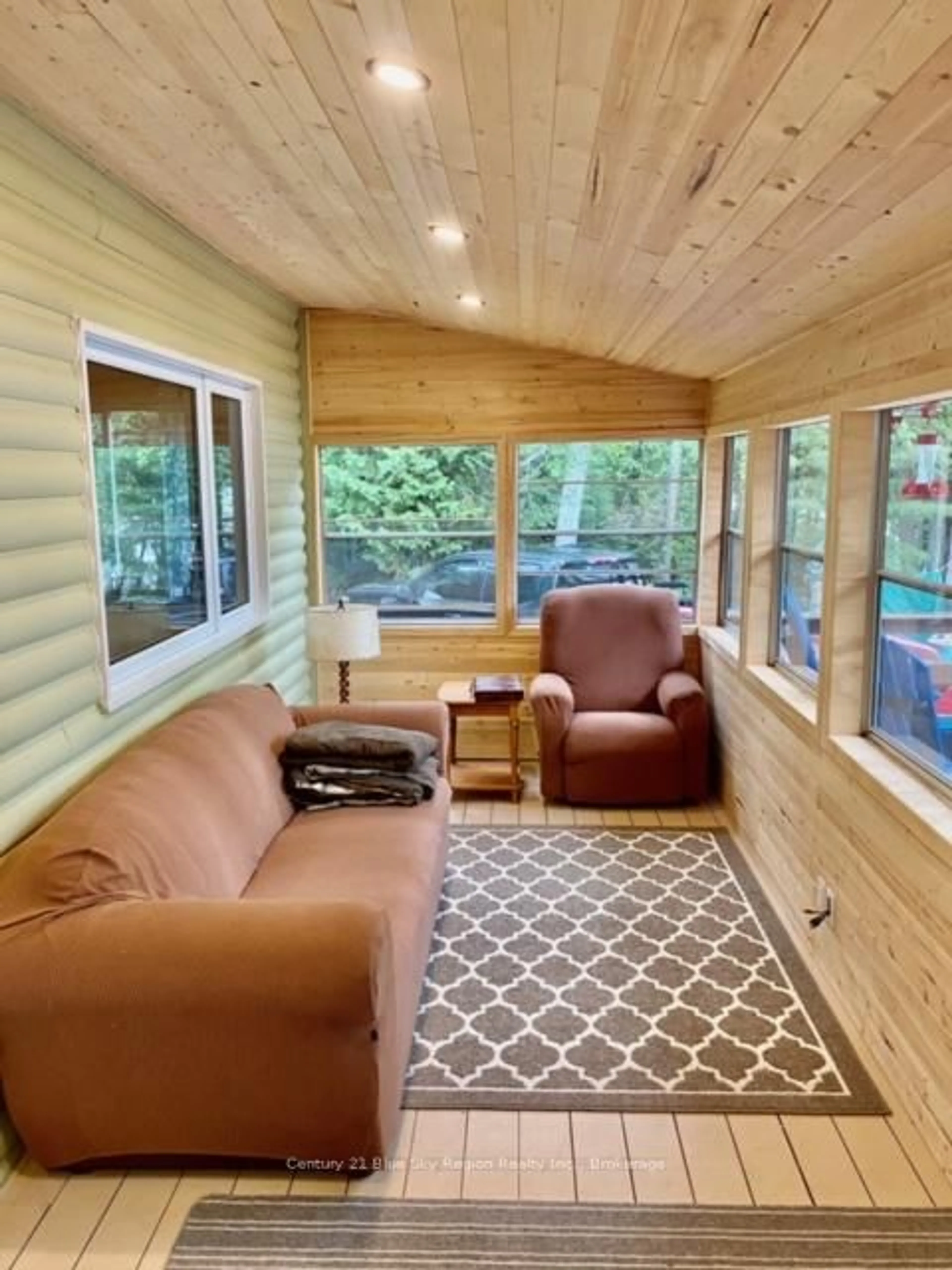 Living room with furniture, wood/laminate floor for 75 Richfield Rd, Temagami Ontario P0H 1T0