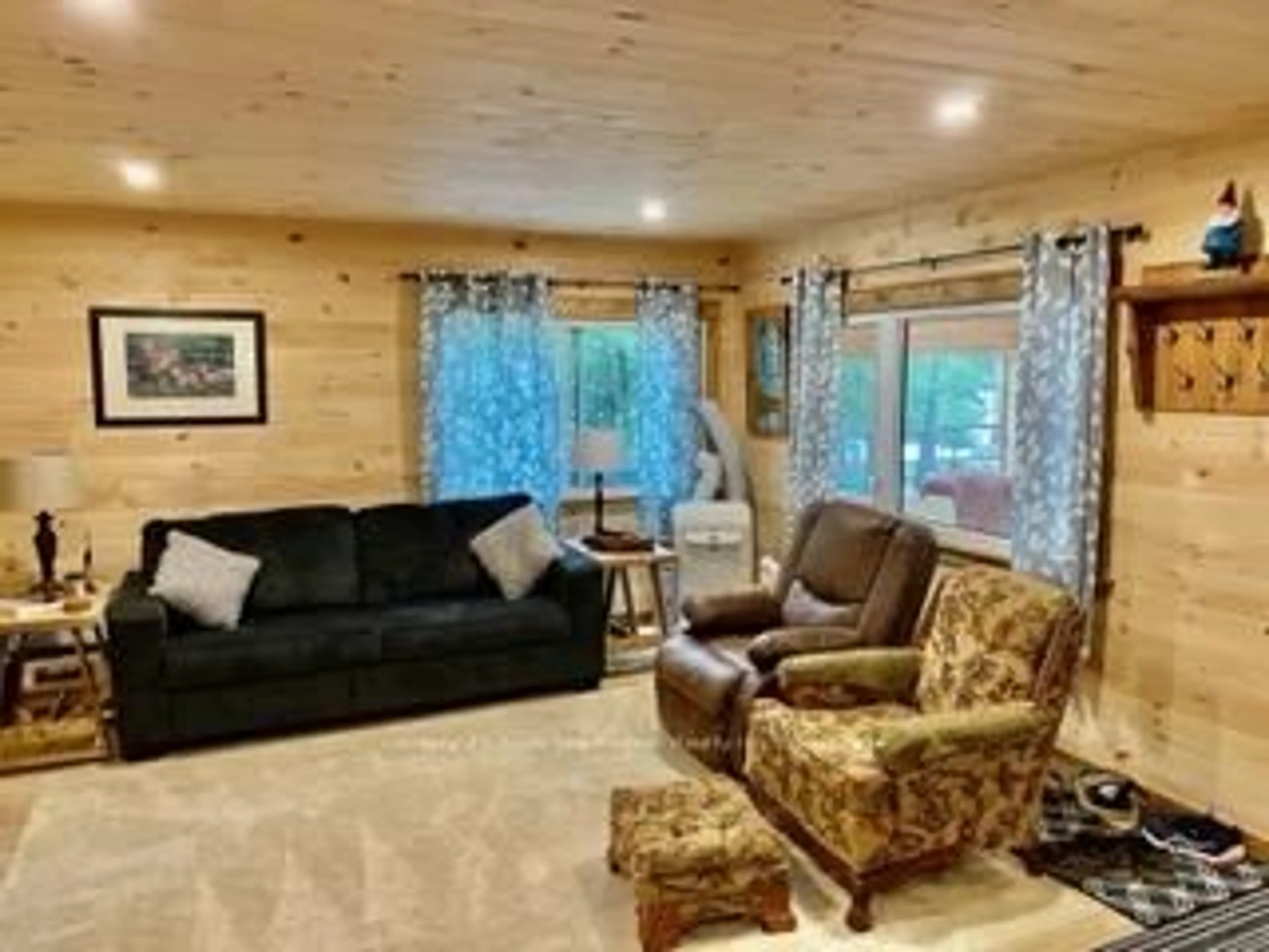 Living room with furniture, wood/laminate floor for 75 Richfield Rd, Temagami Ontario P0H 1T0