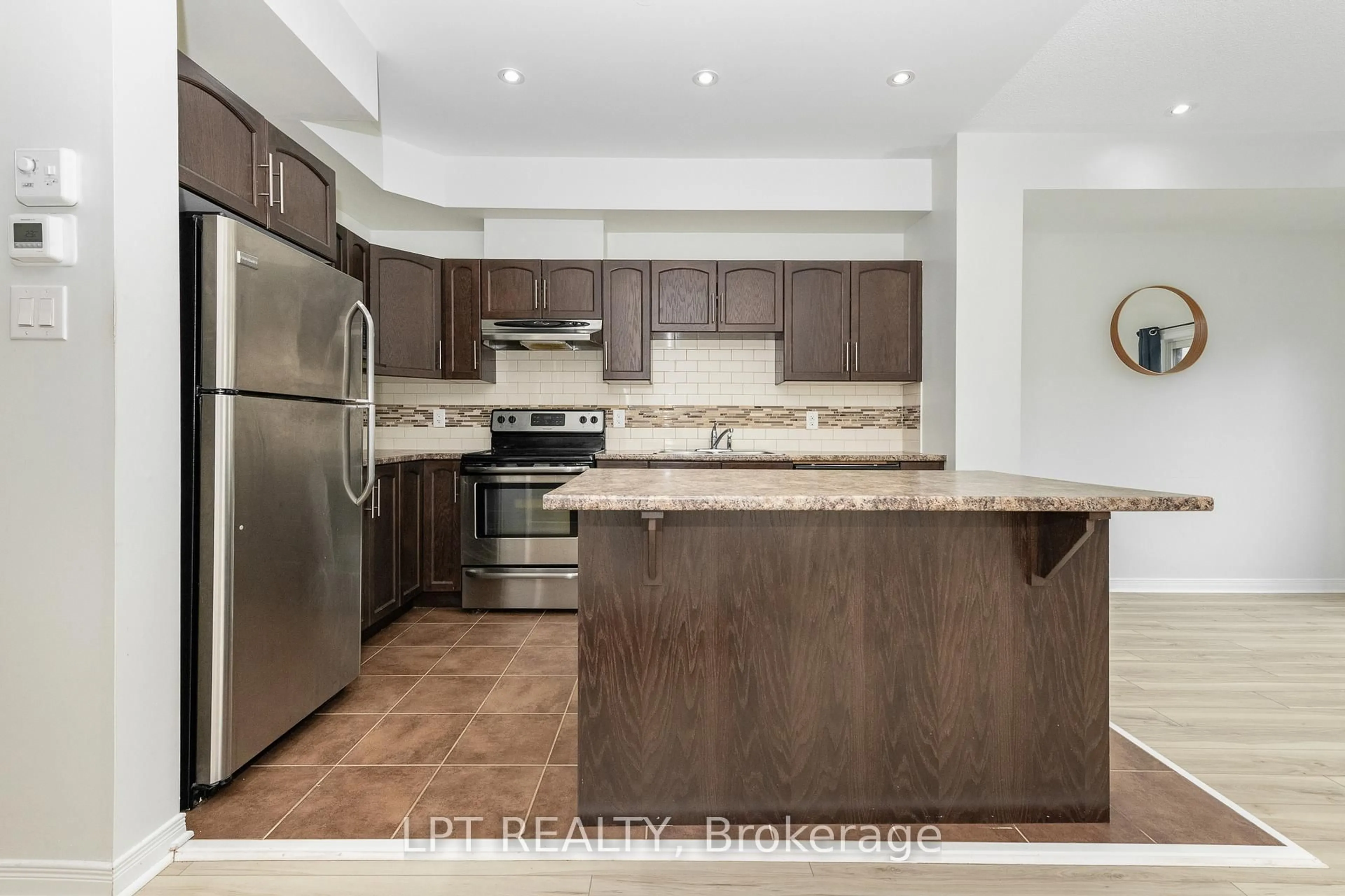 Open concept kitchen, wood/laminate floor for 617 Via Amalfi St, Ottawa Ontario K2J 5X8