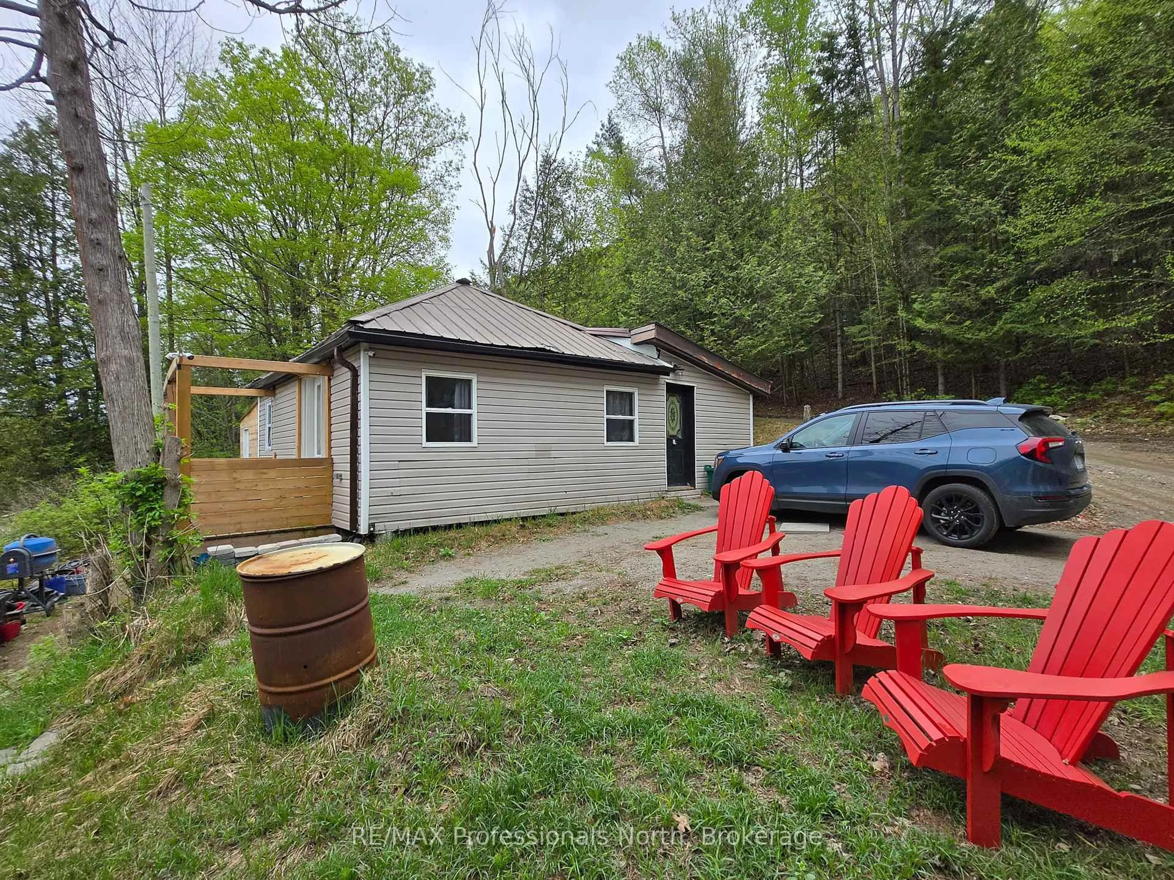 A pic from outside/outdoor area/front of a property/back of a property/a pic from drone, forest/trees view for 18 South St, Dysart et al Ontario K0M 1S0