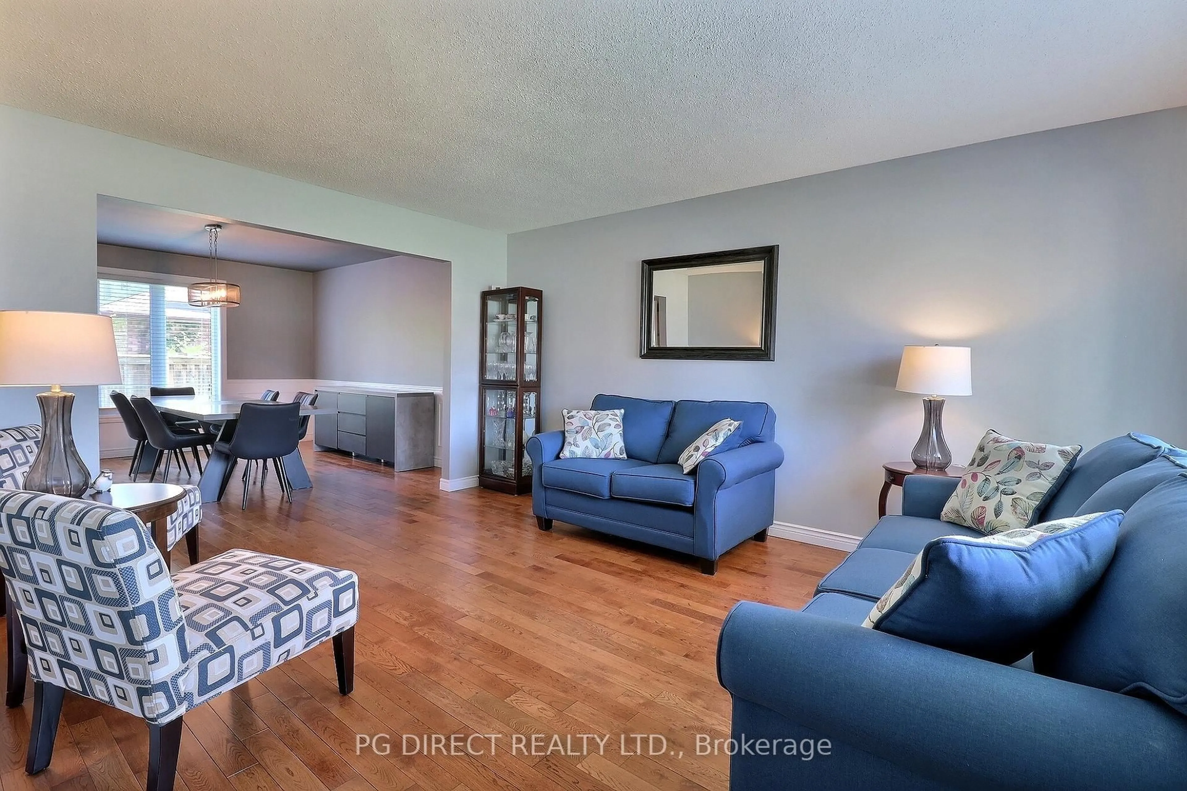 Living room with furniture, wood/laminate floor for 68 Westbrook Cres, Middlesex Centre Ontario N0L 1R0