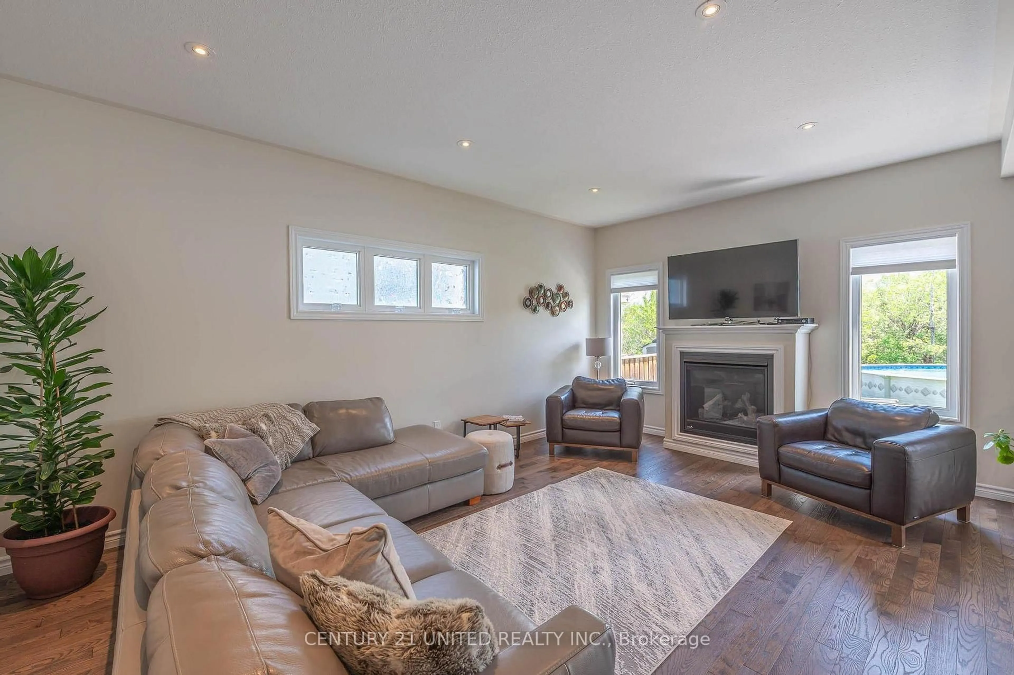 Living room with furniture, wood/laminate floor for 451 Raymond St, Peterborough North Ontario K9H 7P3
