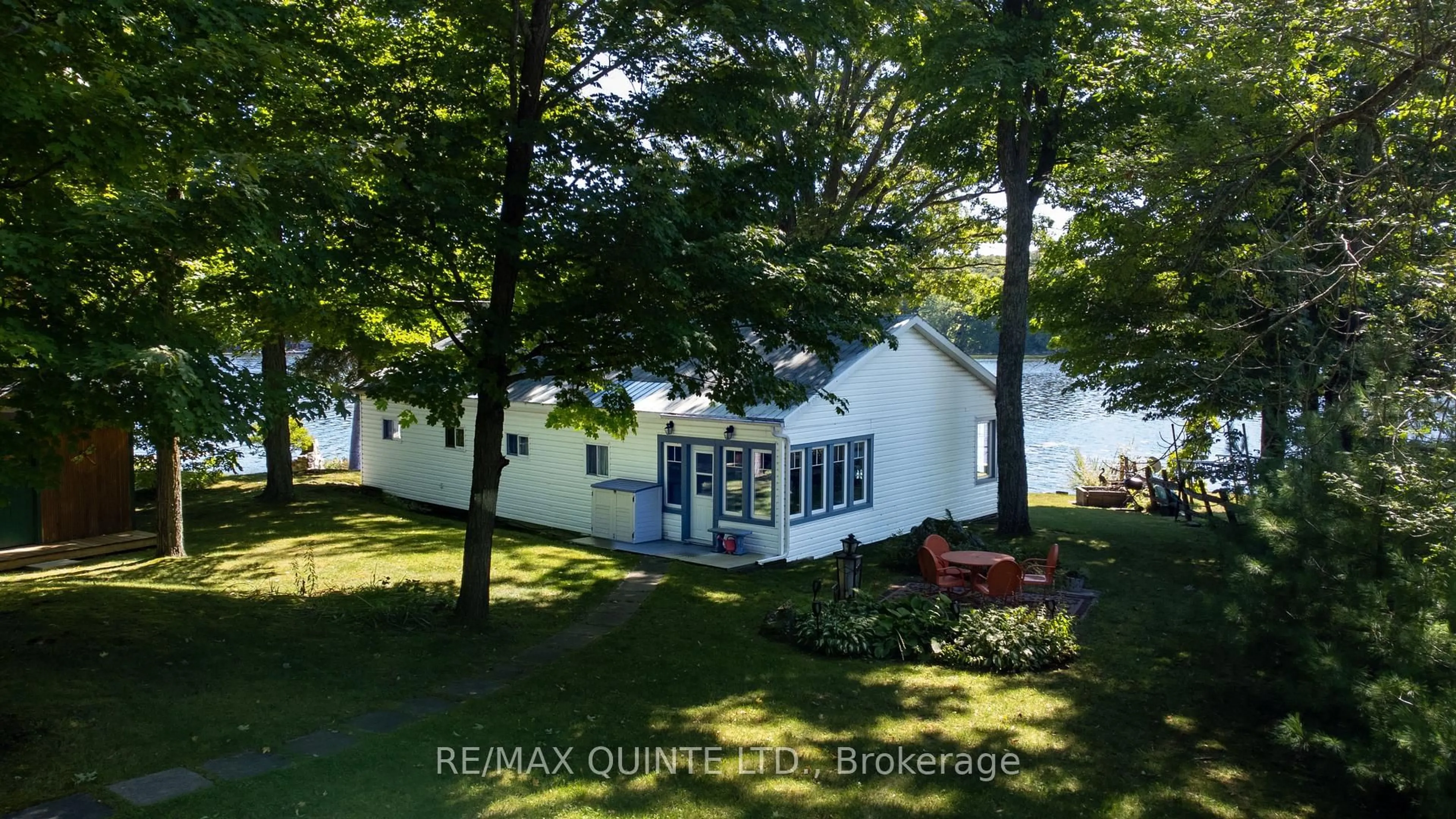A pic from outside/outdoor area/front of a property/back of a property/a pic from drone, water/lake/river/ocean view for 597 Pine Point Lane, Madoc Ontario K0K 2K0