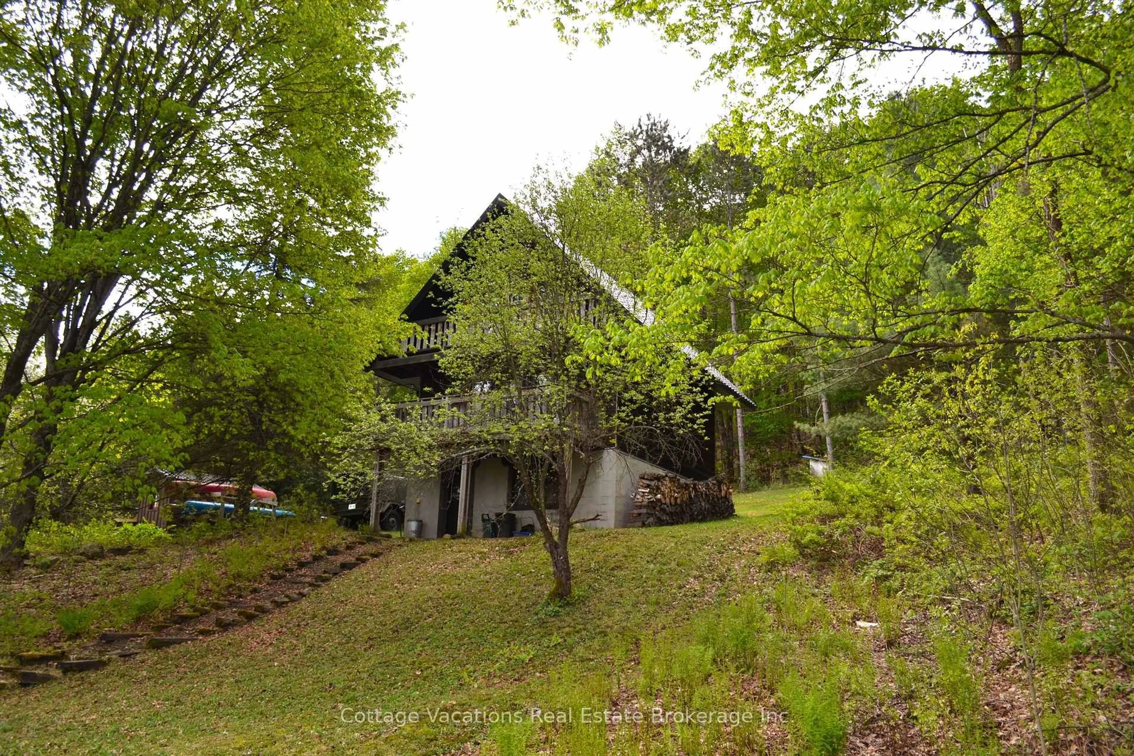 A pic from outside/outdoor area/front of a property/back of a property/a pic from drone, forest/trees view for 527 Aspdin Rd, Huntsville Ontario P1H 1Y4