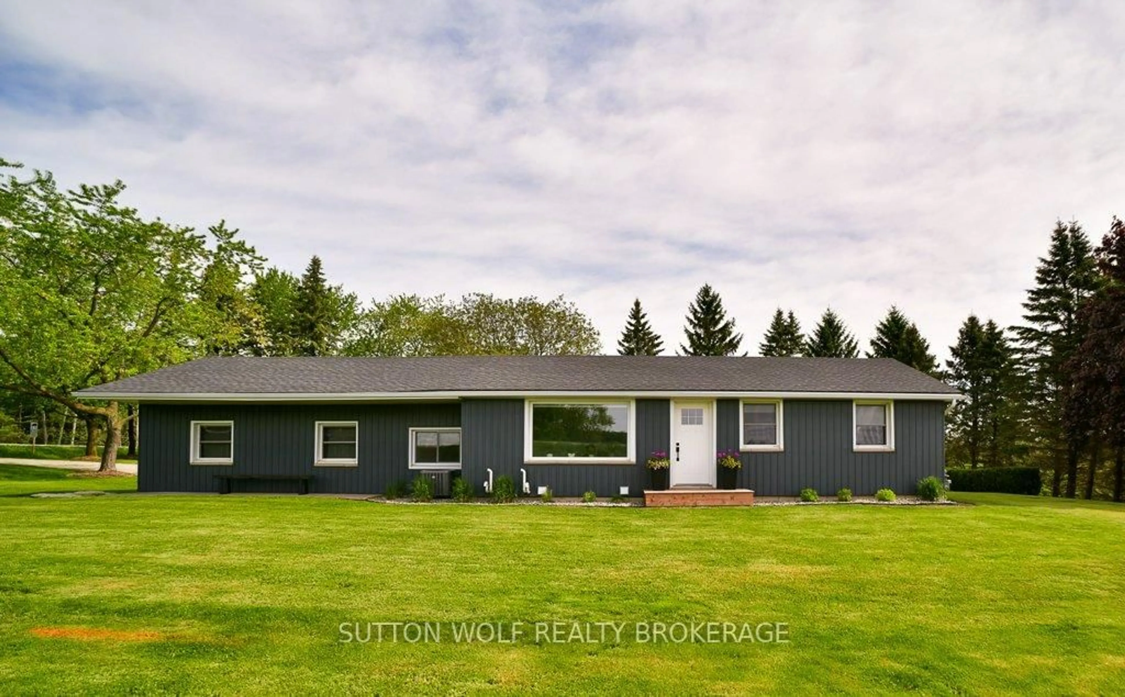 Home with vinyl exterior material, street for 30458 Sylvan Rd, North Middlesex Ontario N0M 2K0