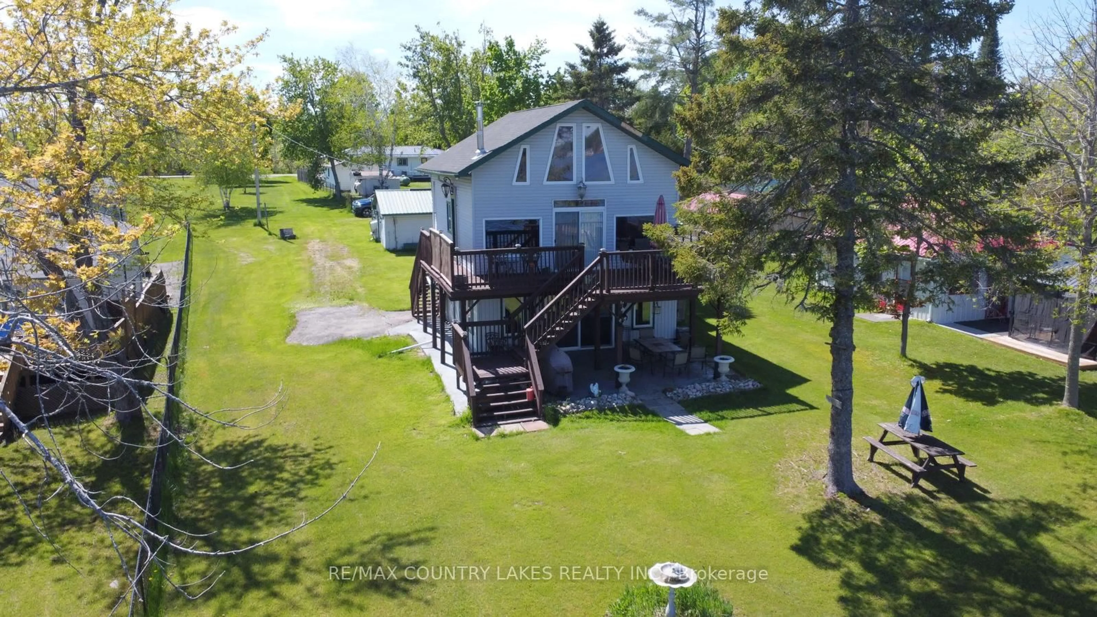 A pic from outside/outdoor area/front of a property/back of a property/a pic from drone, water/lake/river/ocean view for 8 Saturn Lane, Kawartha Lakes Ontario K0M 2B0