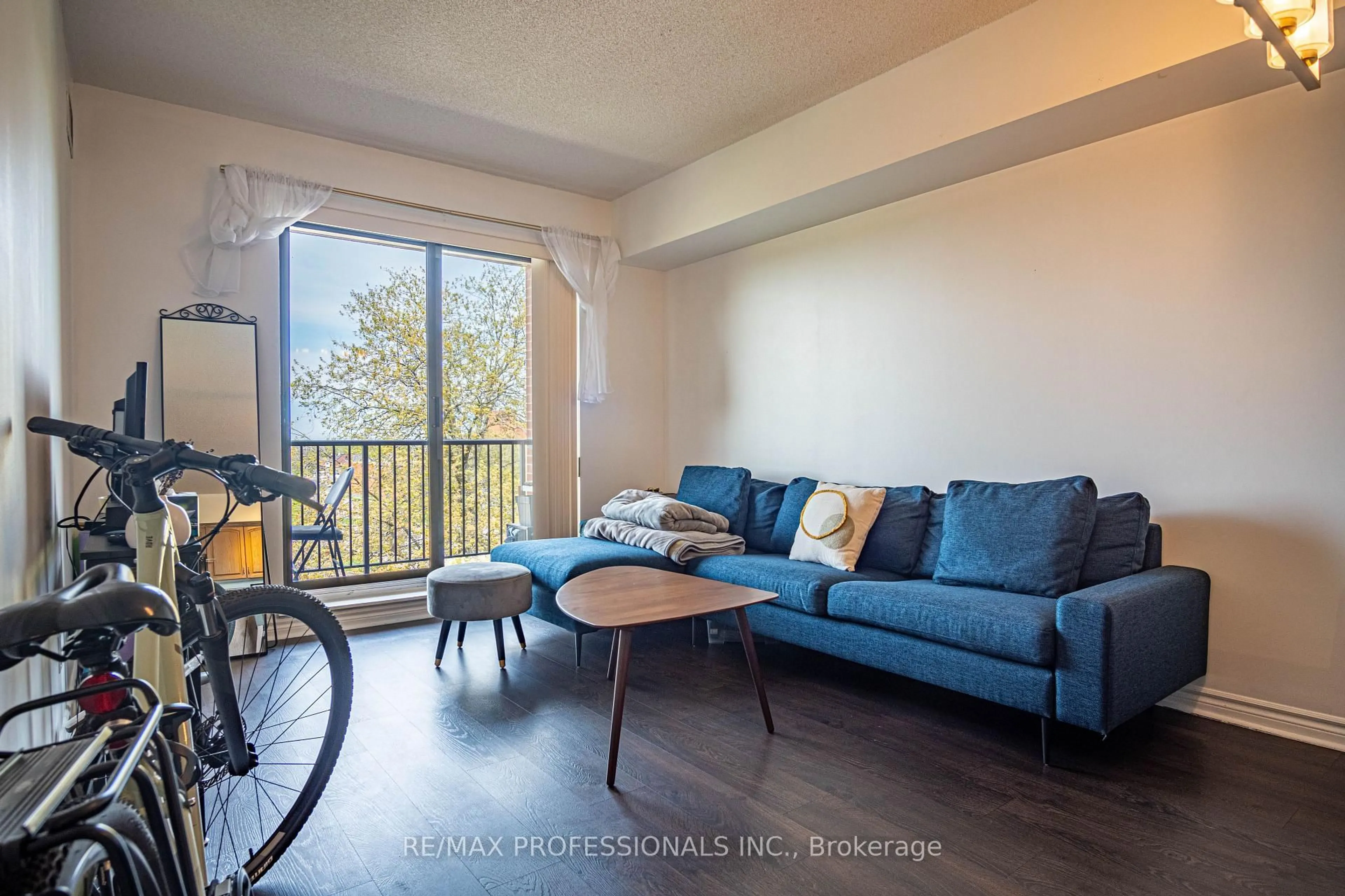 Living room with furniture, wood/laminate floor for 47 Caroline St #502, Hamilton Ontario L8R 2R6