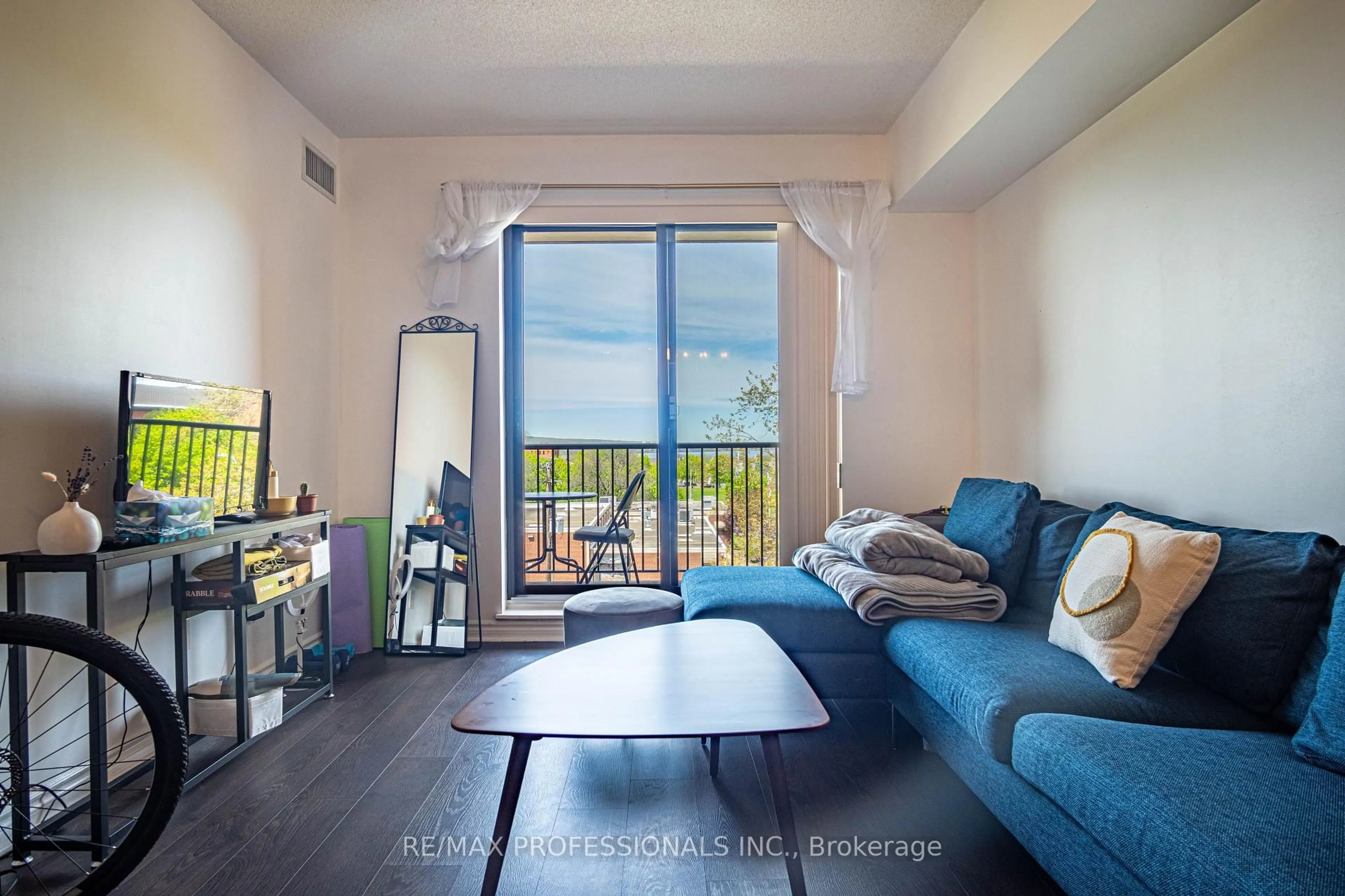 Living room with furniture, wood/laminate floor for 47 Caroline St #502, Hamilton Ontario L8R 2R6