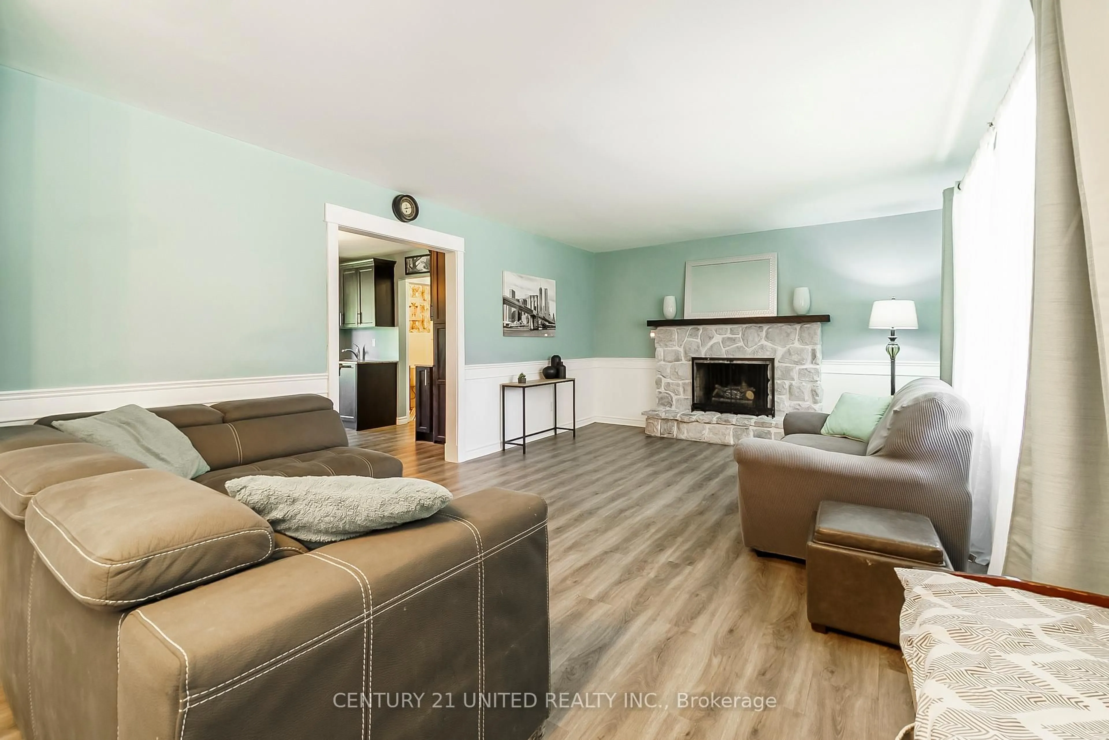 Living room with furniture, wood/laminate floor for 862 Lily Lake Rd, Selwyn Ontario K9J 6X3