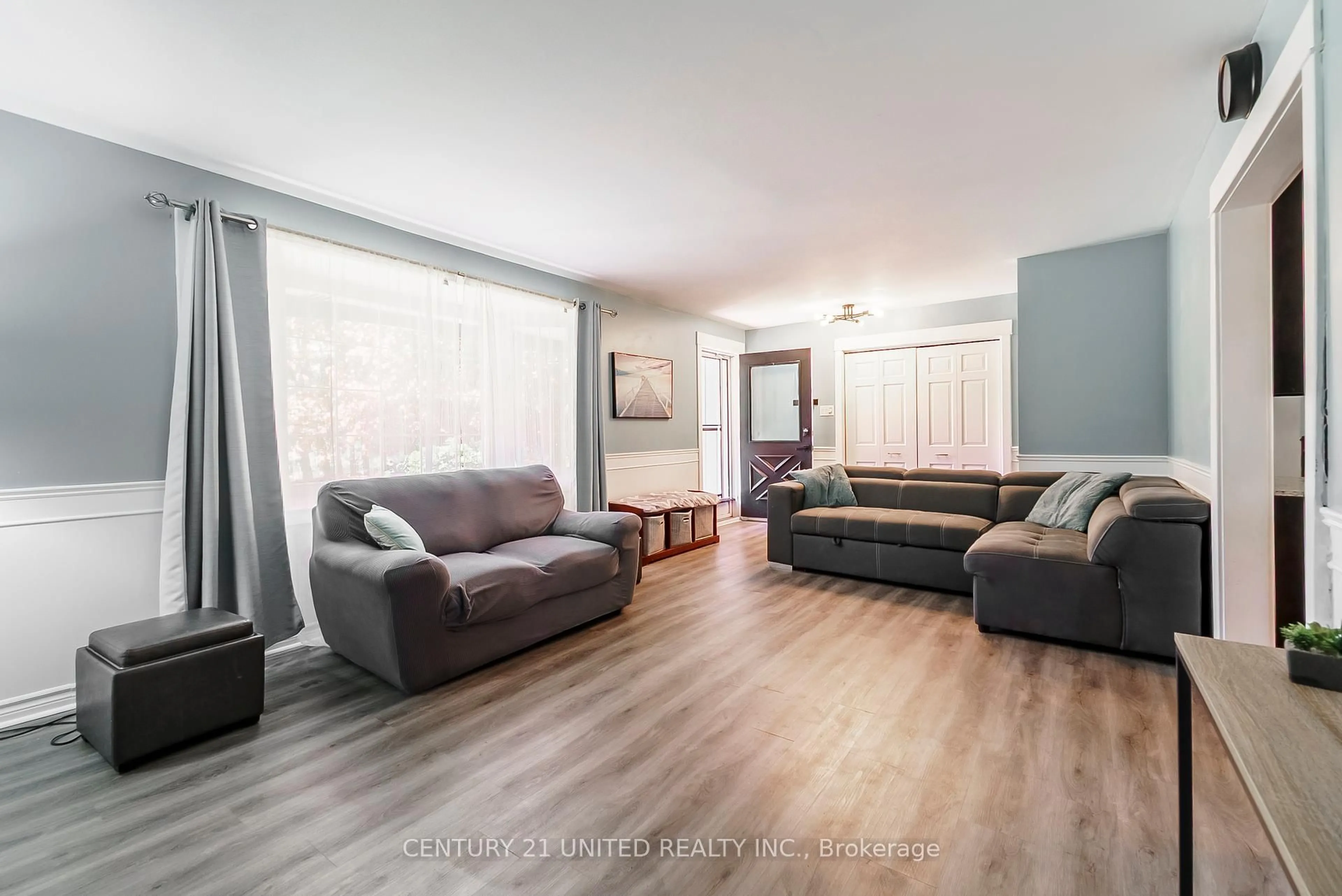 Living room with furniture, wood/laminate floor for 862 Lily Lake Rd, Selwyn Ontario K9J 6X3