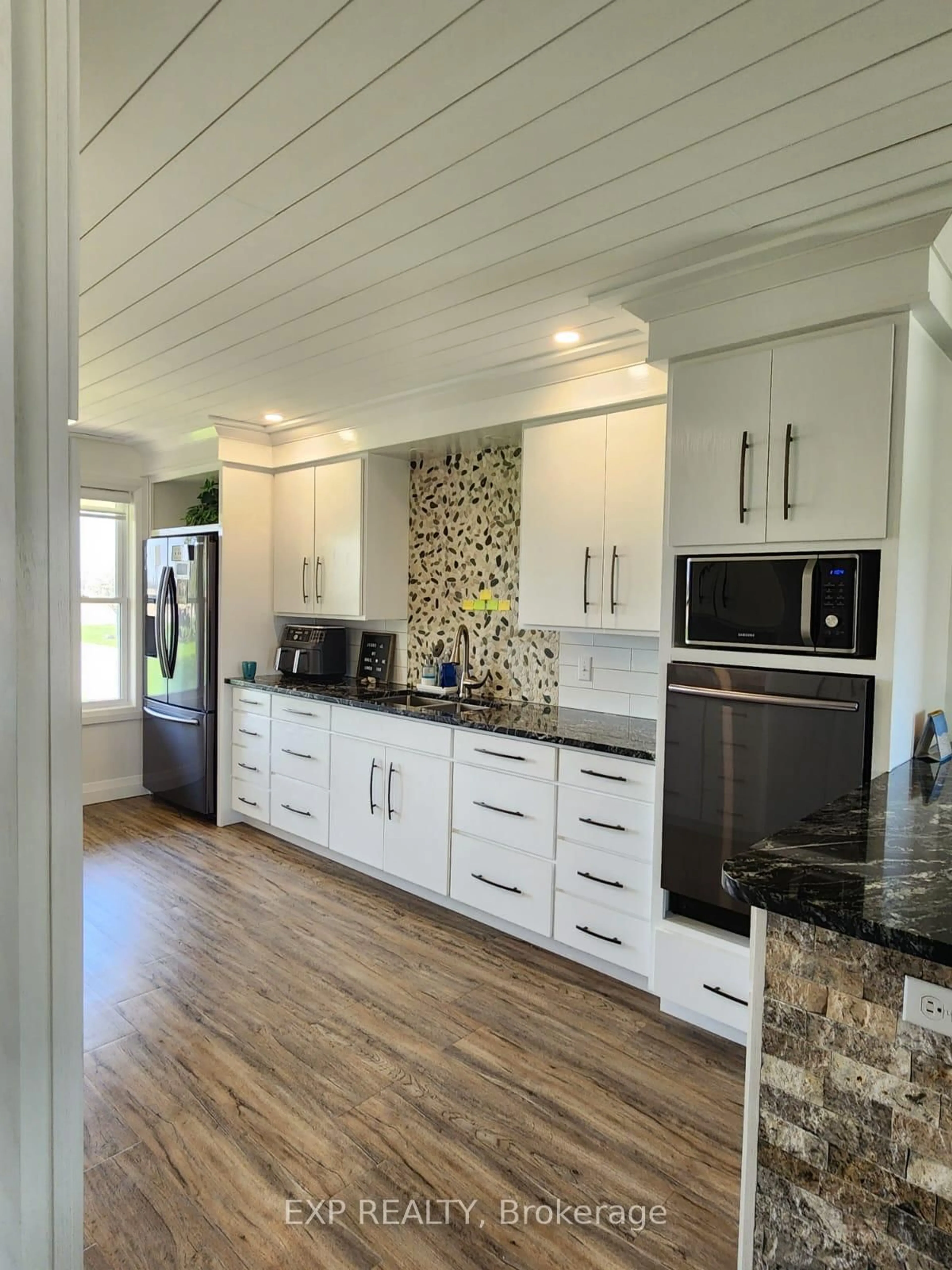 Open concept kitchen, wood/laminate floor for 20357 Port Rd, Chatham-Kent Ontario N0P 1W0