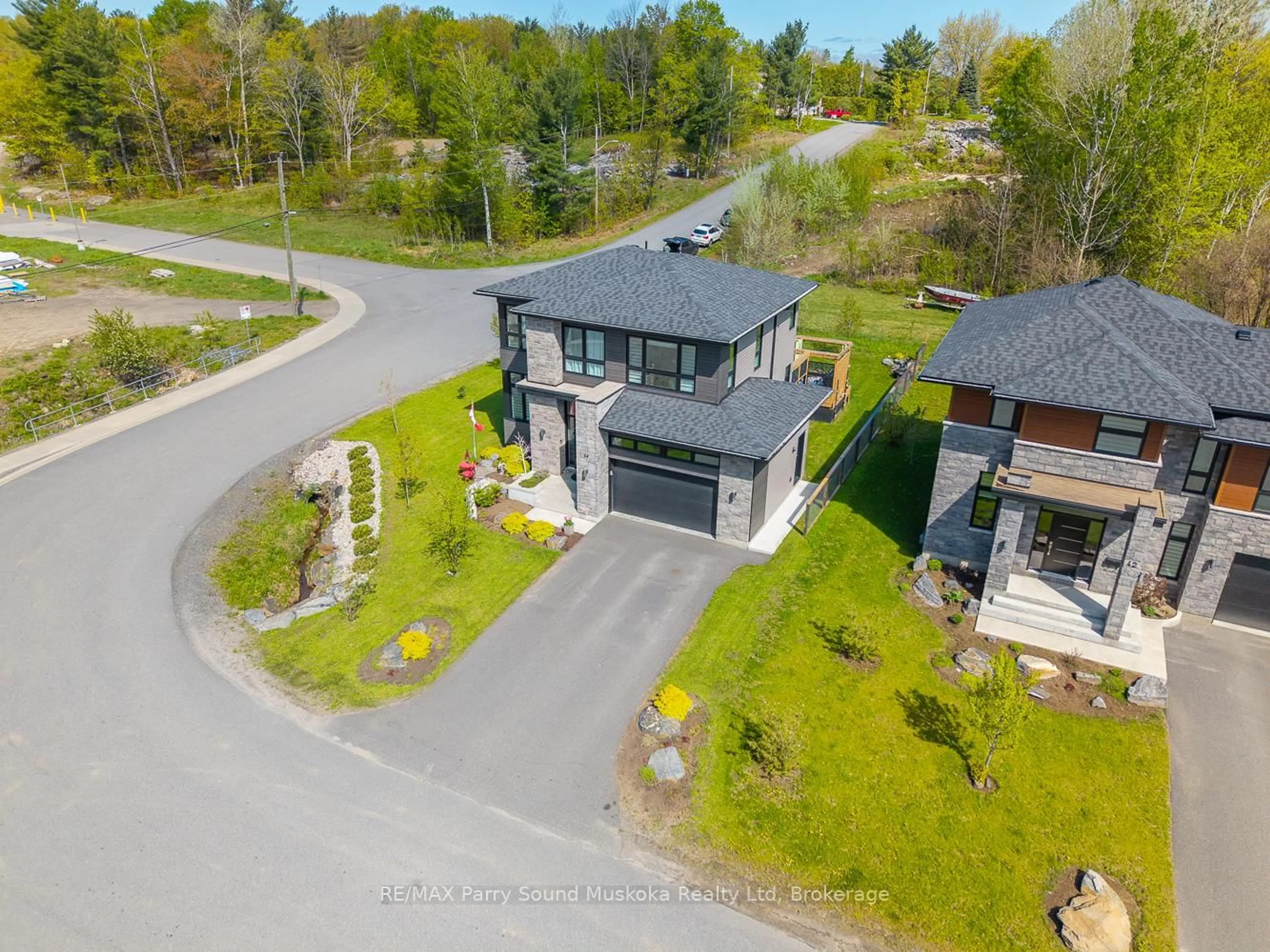 A pic from outside/outdoor area/front of a property/back of a property/a pic from drone, unknown for 44 Dennis Dr, Parry Sound Ontario P2A 0E6
