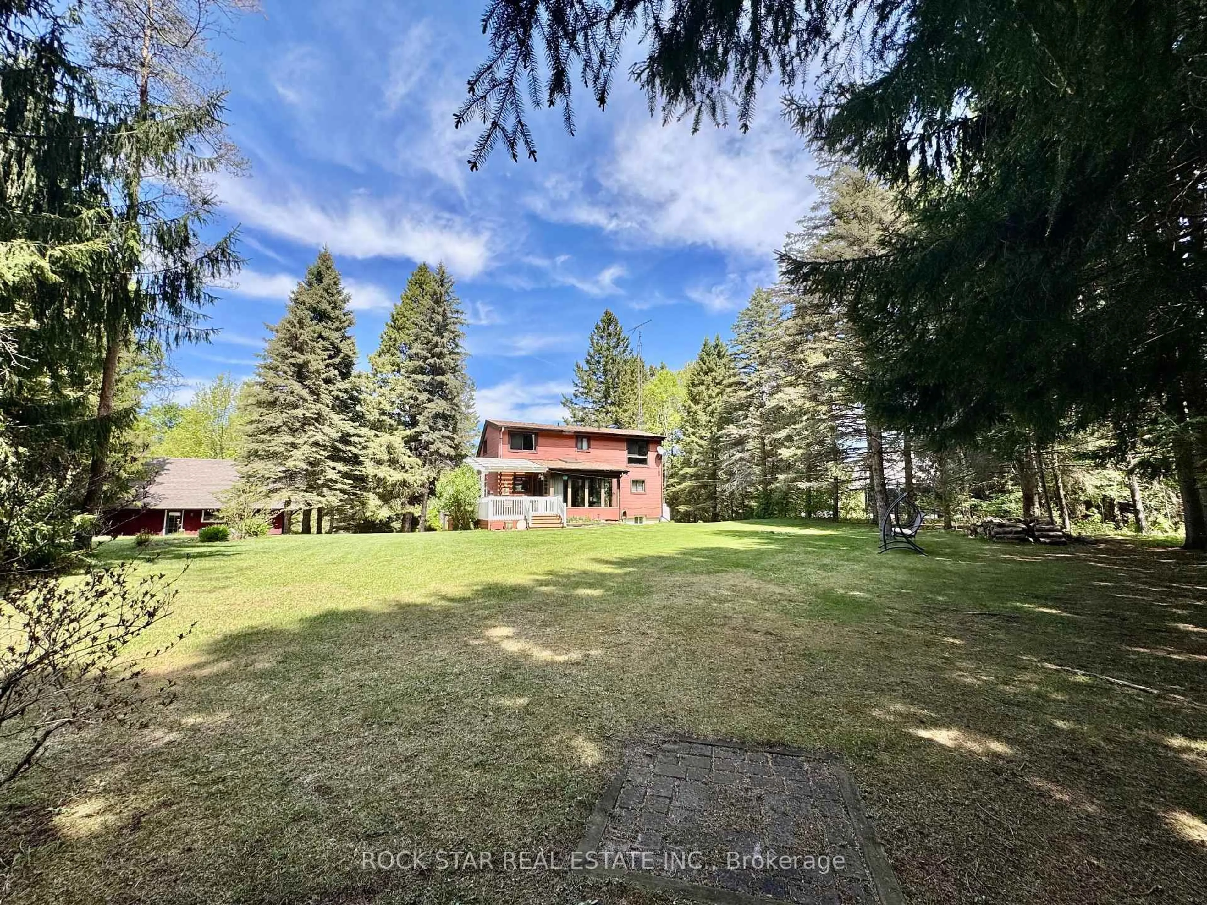 A pic from outside/outdoor area/front of a property/back of a property/a pic from drone, forest/trees view for 8 Pine River Cres, Mulmur Ontario L9V 3H2