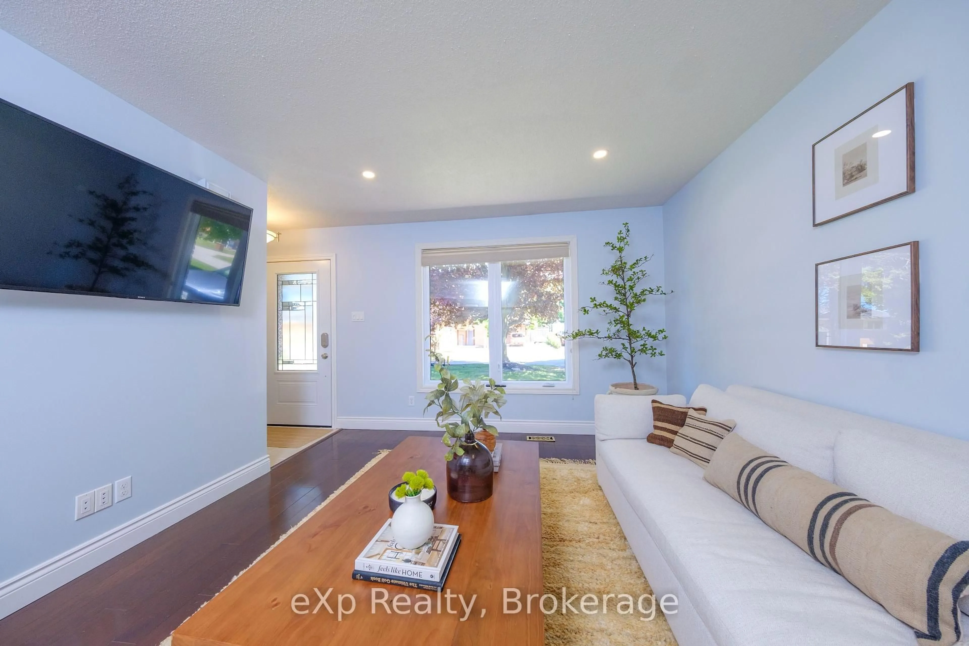 Living room with furniture, wood/laminate floor for 484 Falconer St, Saugeen Shores Ontario N0H 2C2