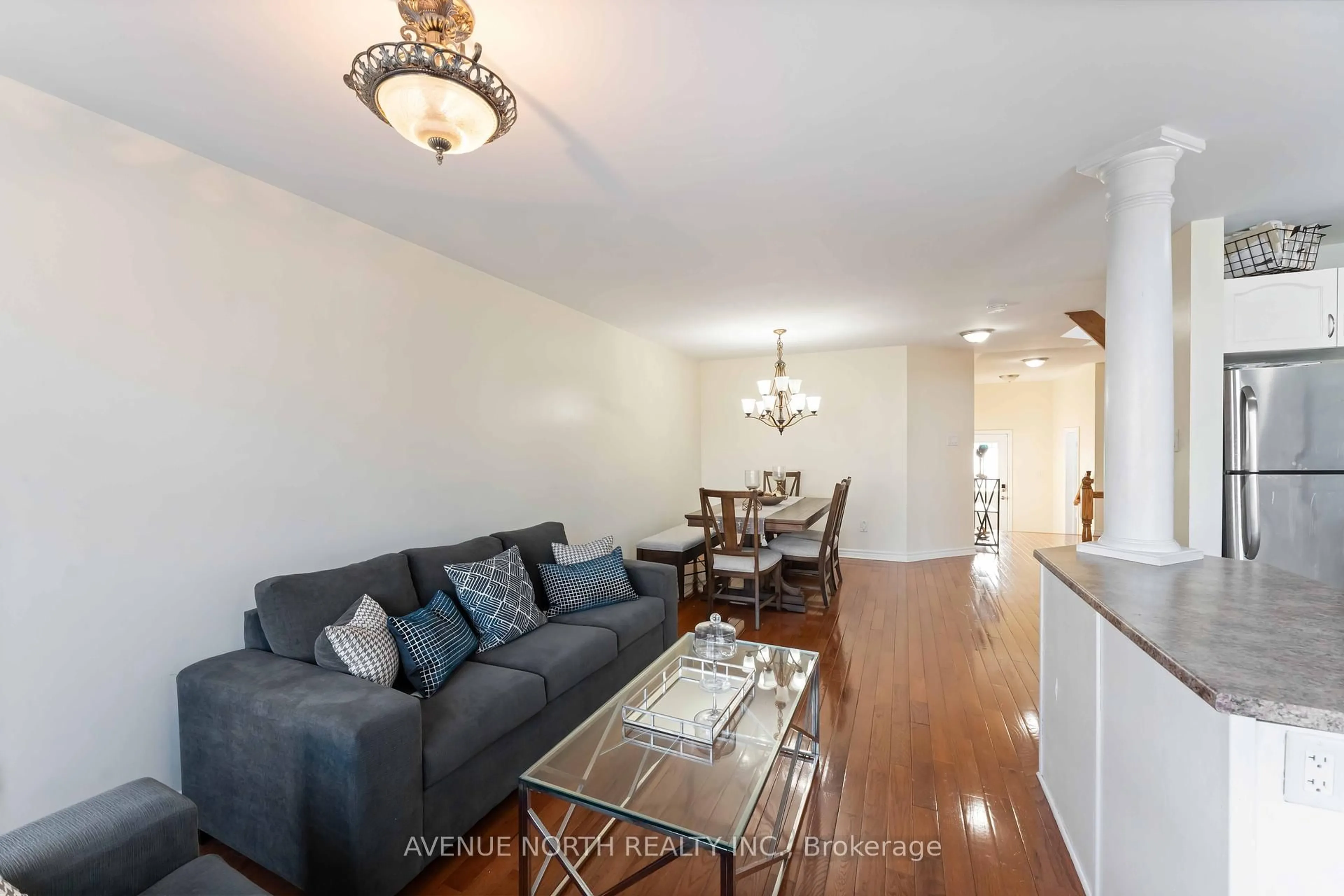 Living room with furniture, wood/laminate floor for 184 Montmorency Way, Ottawa Ontario K4A 0J3