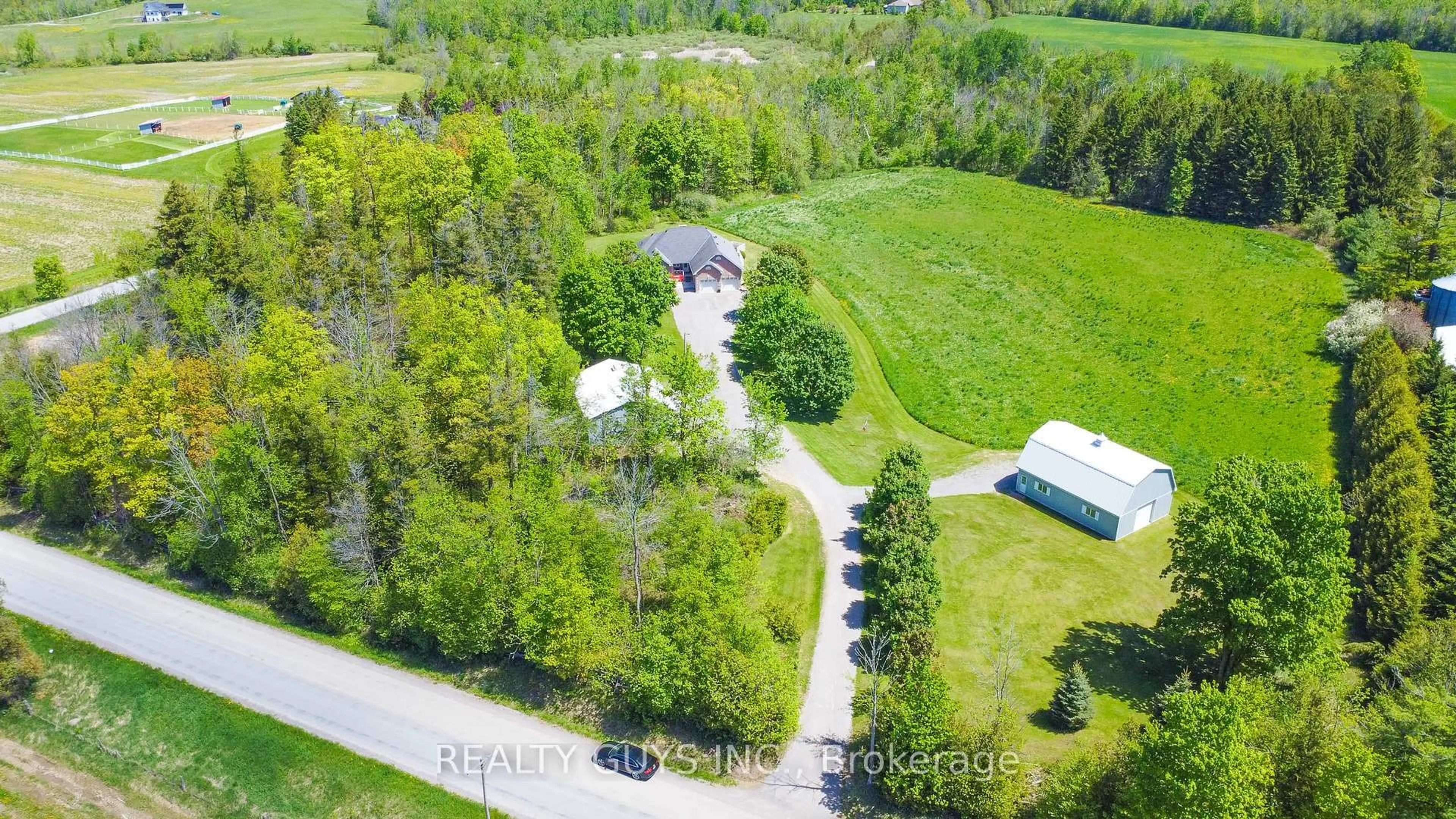 A pic from outside/outdoor area/front of a property/back of a property/a pic from drone, forest/trees view for 1417 Drummond Line, Otonabee-South Monaghan Ontario K9J 6X8
