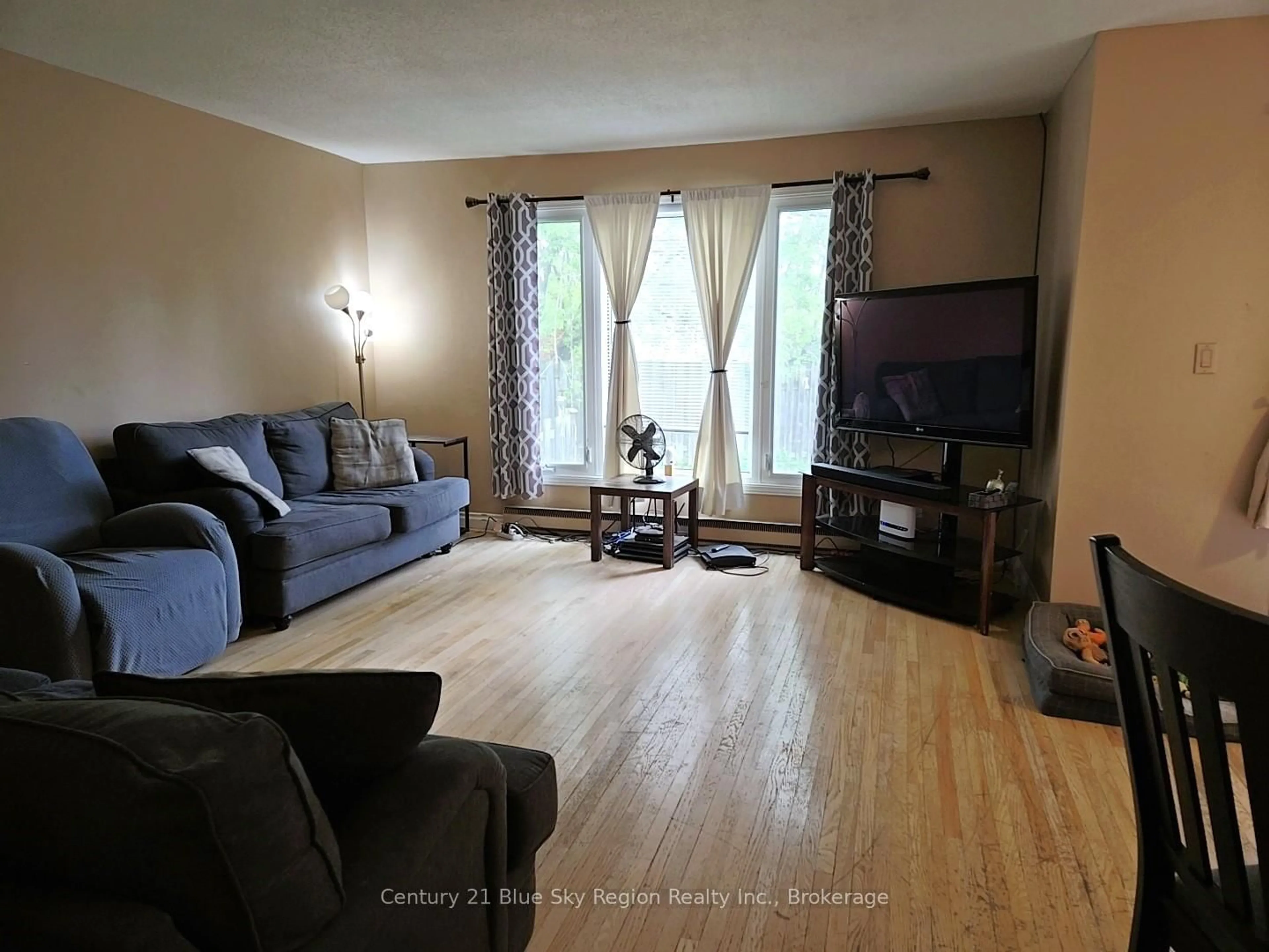 Living room with furniture, wood/laminate floor for 621 Gormanville Rd #6, North Bay Ontario P1B 8N9