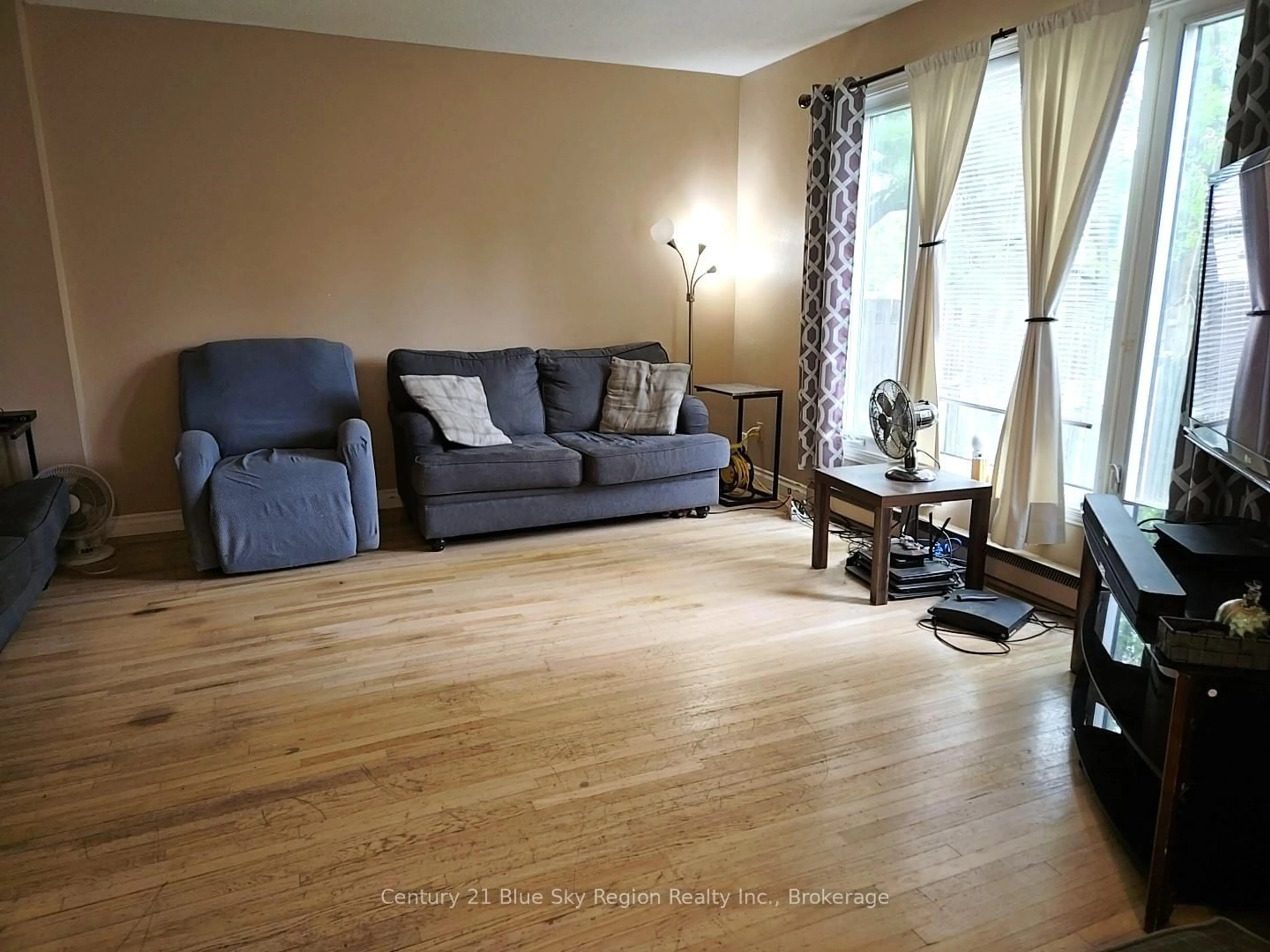 Living room with furniture, wood/laminate floor for 621 Gormanville Rd #6, North Bay Ontario P1B 8N9