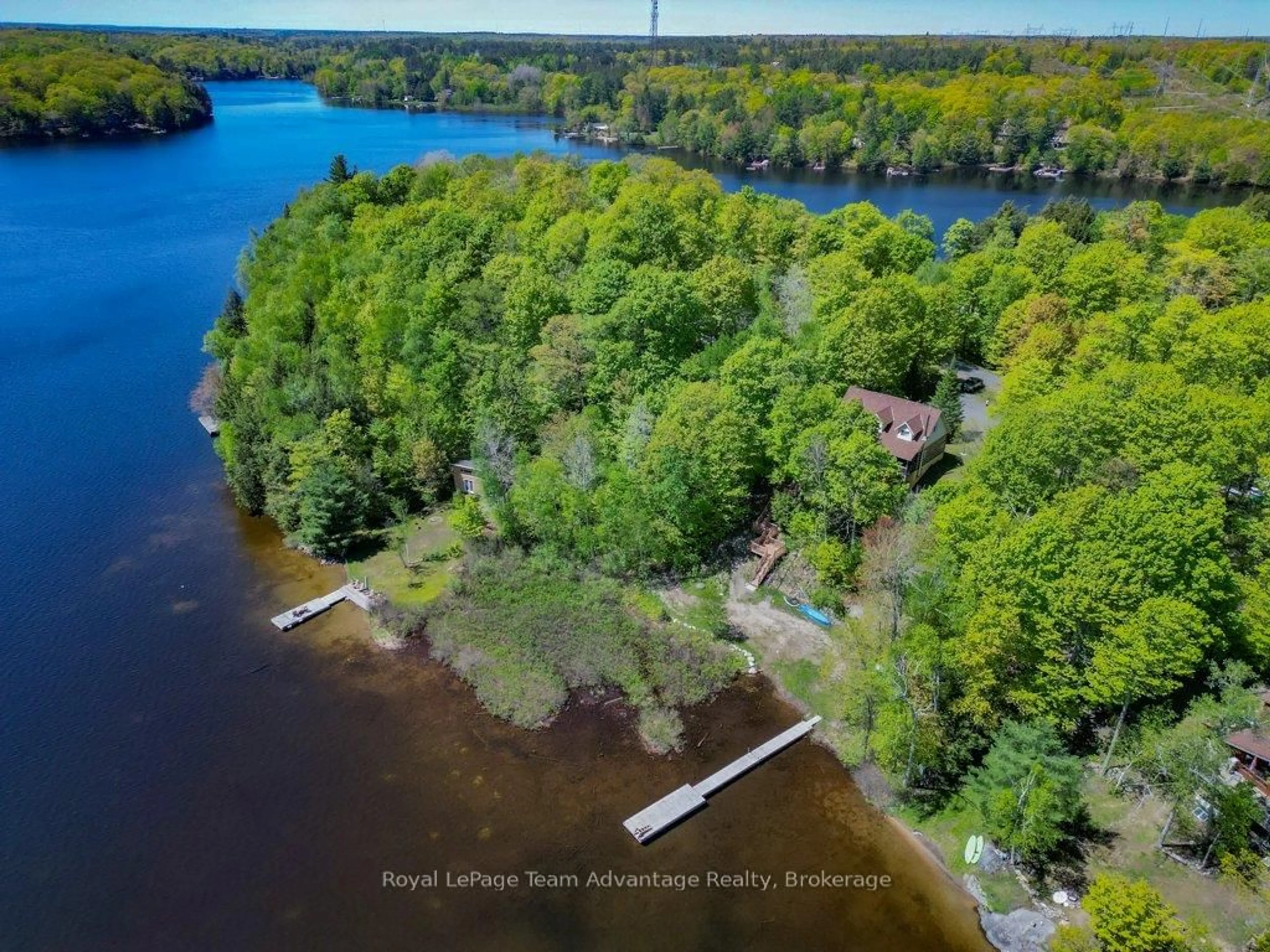 A pic from outside/outdoor area/front of a property/back of a property/a pic from drone, water/lake/river/ocean view for 52 Little Otter Lane, Seguin Ontario P2A 0B2