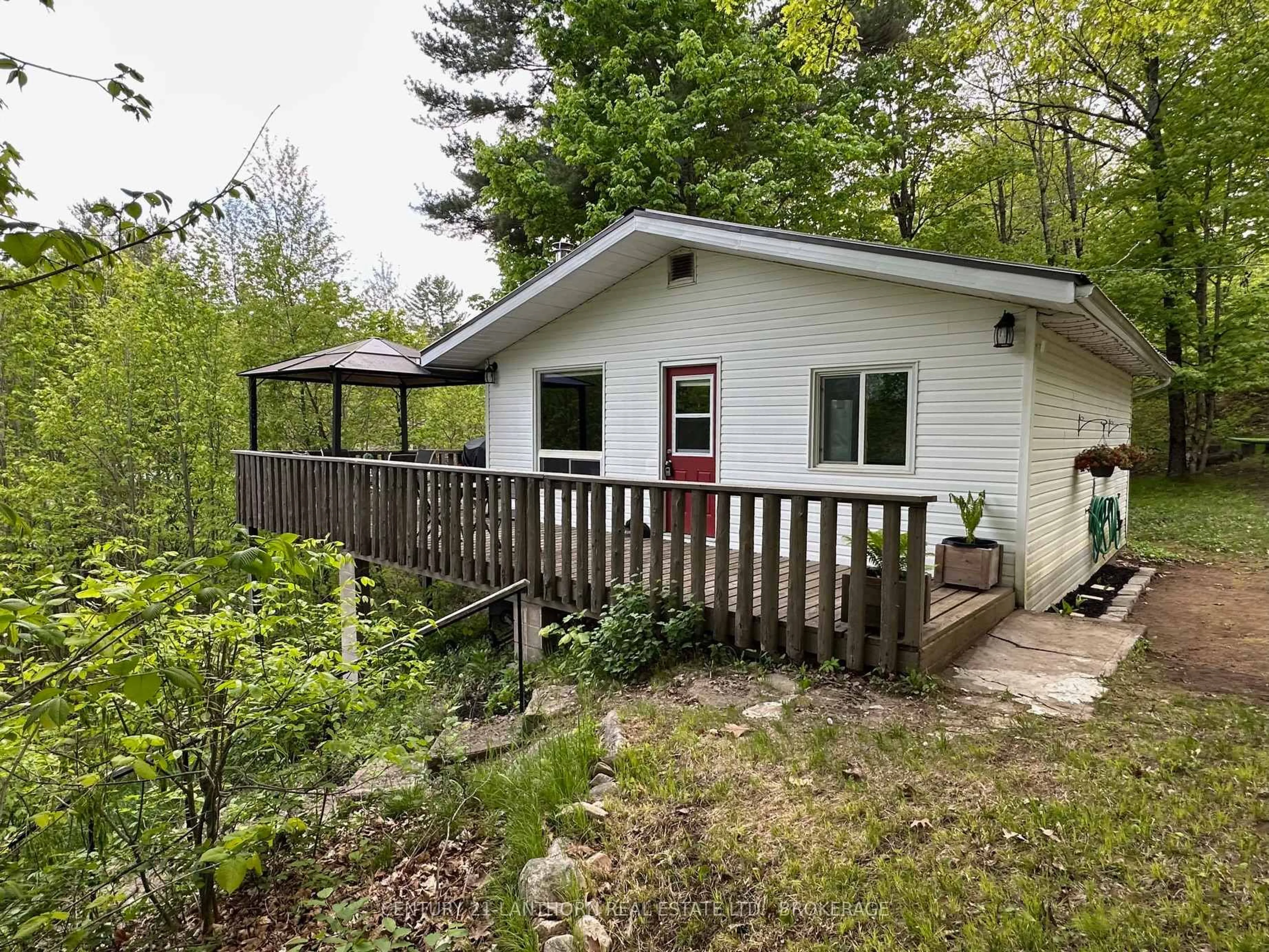A pic from outside/outdoor area/front of a property/back of a property/a pic from drone, forest/trees view for 1024 Harrington Lane, Arden Ontario K0H 1B0