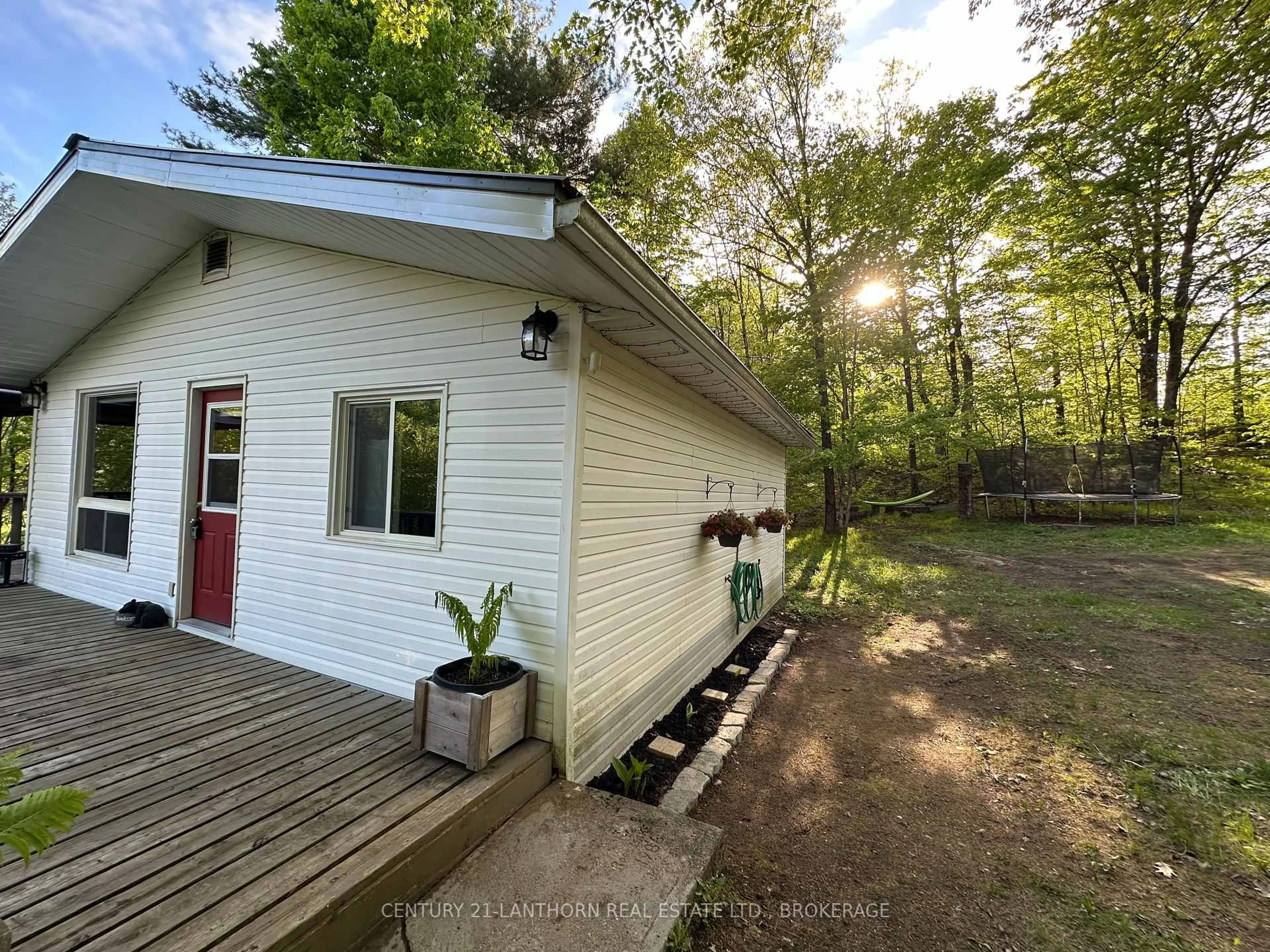 A pic from outside/outdoor area/front of a property/back of a property/a pic from drone, forest/trees view for 1024 Harrington Lane, Arden Ontario K0H 1B0