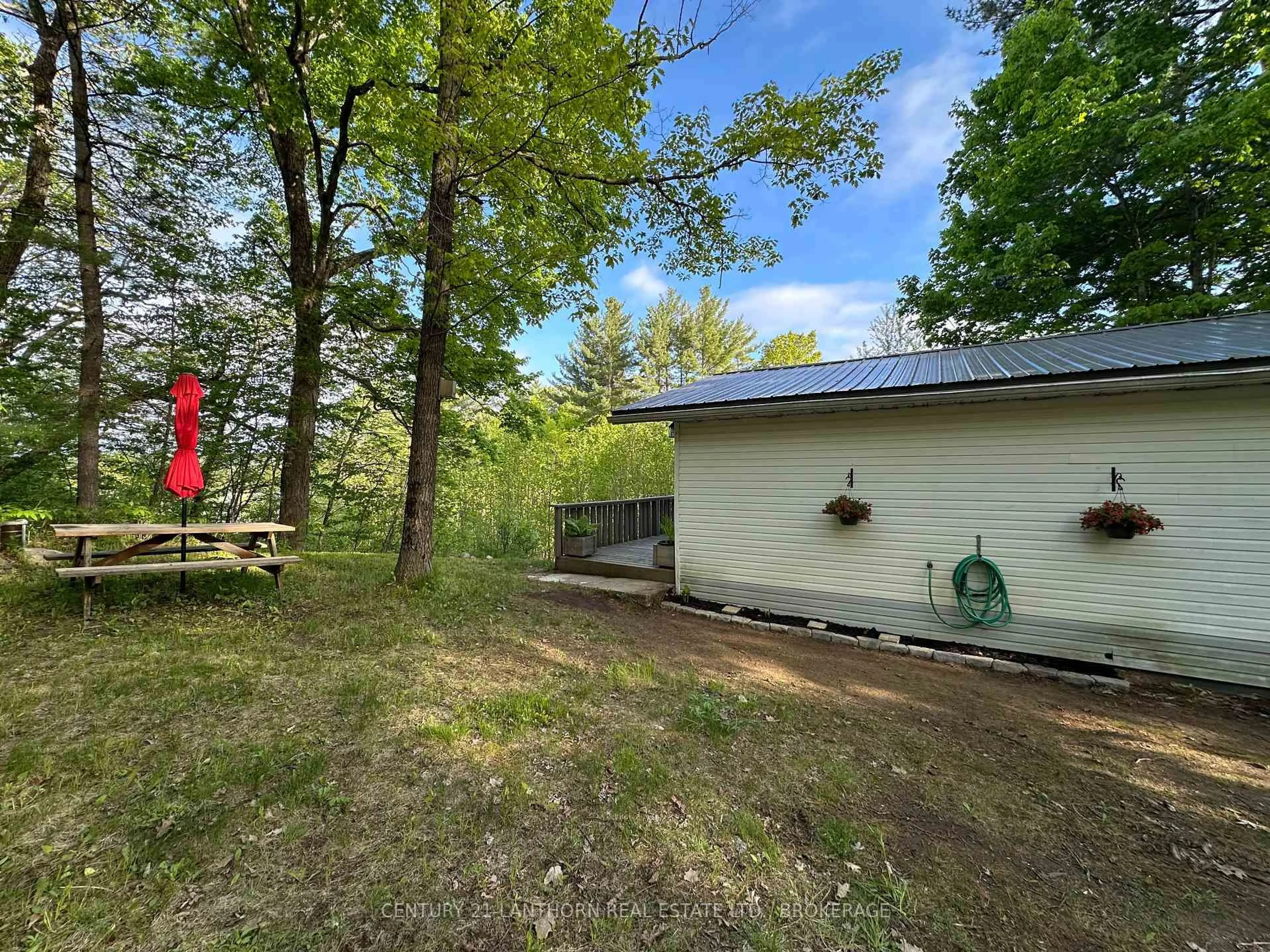 A pic from outside/outdoor area/front of a property/back of a property/a pic from drone, forest/trees view for 1024 Harrington Lane, Arden Ontario K0H 1B0