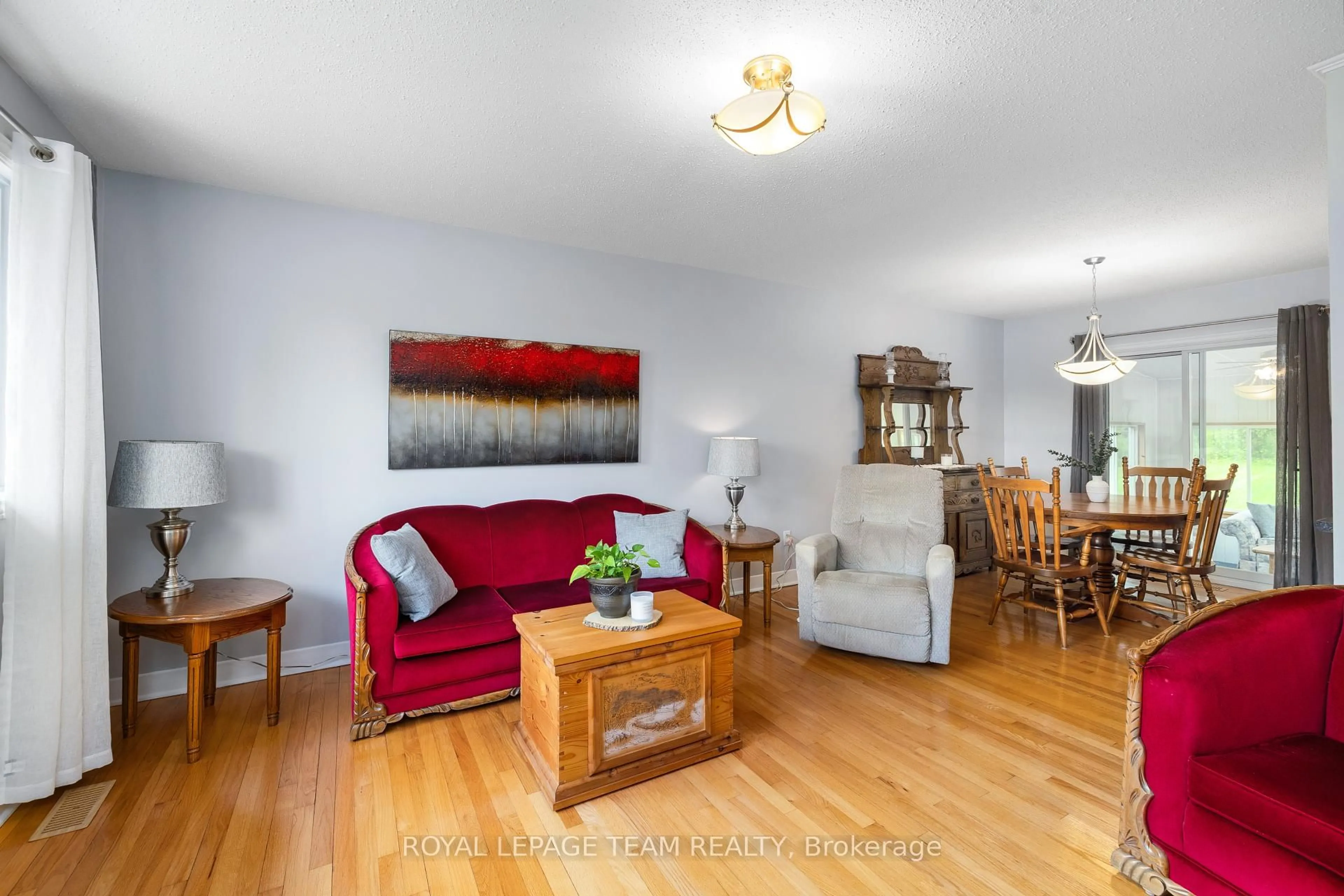 Living room with furniture, wood/laminate floor for 2608 Brentwood Ave, Metcalfe Ontario K0A 2P0