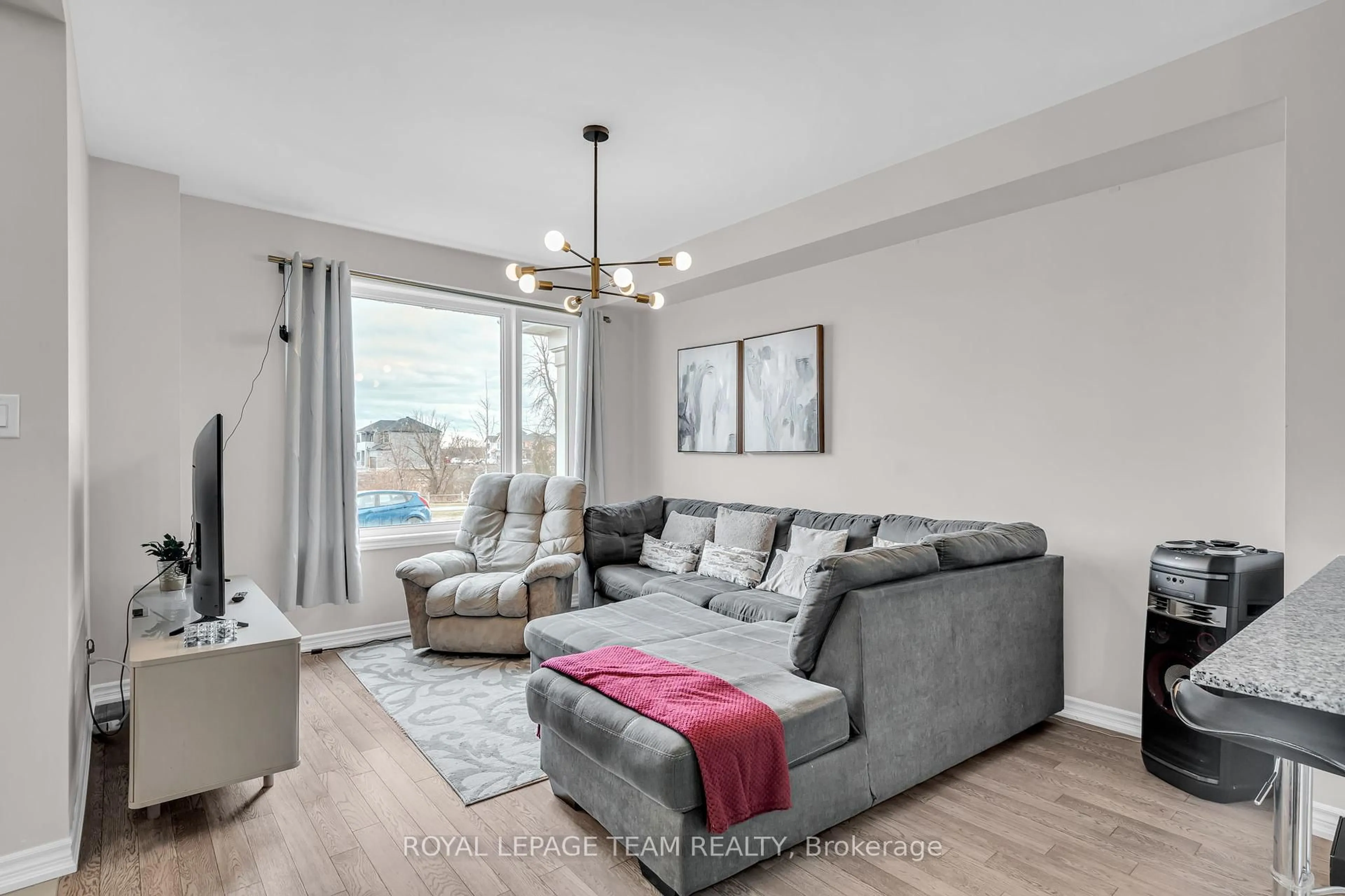 Living room with furniture, wood/laminate floor for 813 Beatrice Peak Crt, Ottawa Ontario K2J 6T6