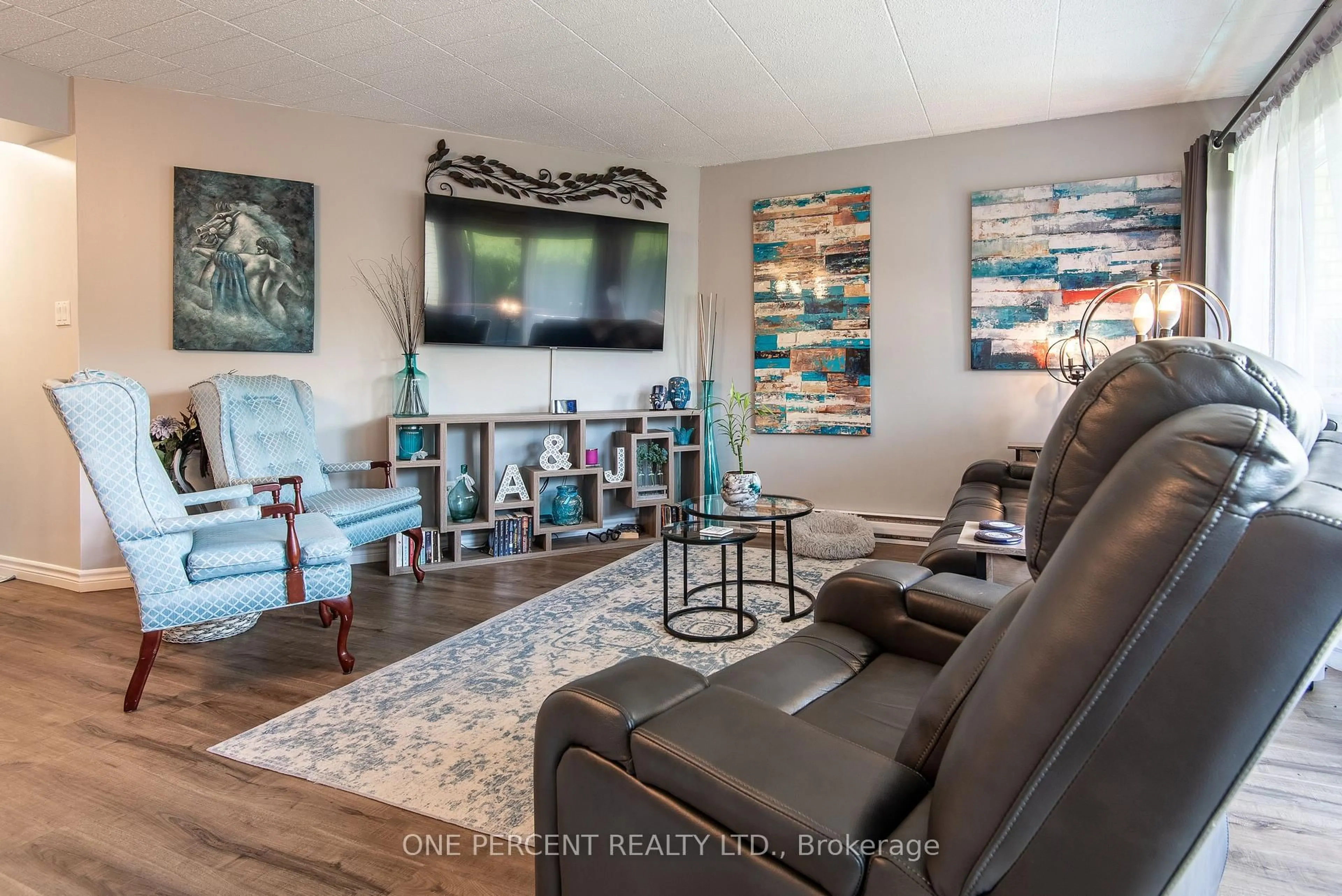 Living room with furniture, wood/laminate floor for 105 Conroy Cres #103, Guelph Ontario N1G 2V5