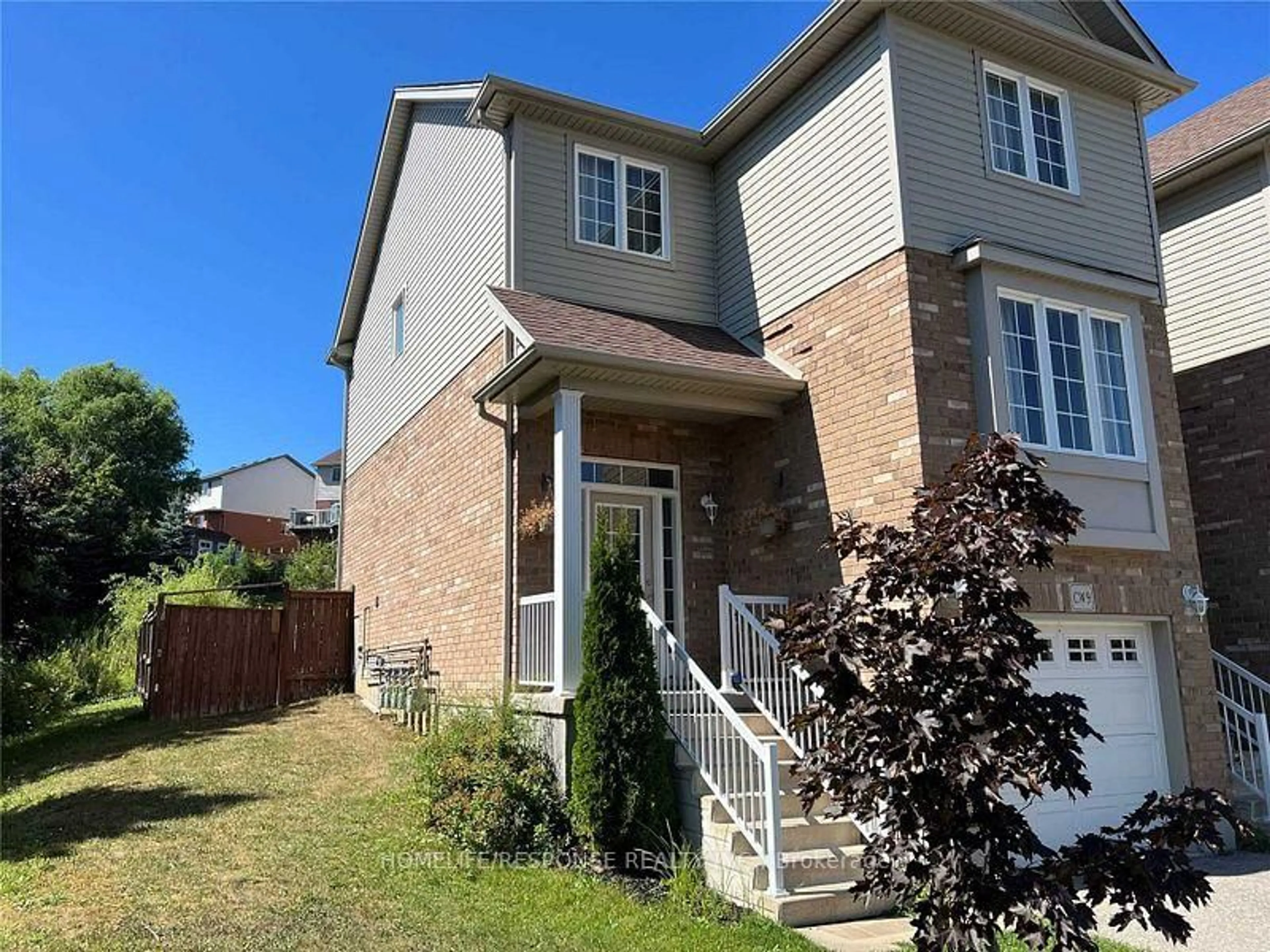 Home with brick exterior material, street for 305 BRIARMEADOW Dr #9, Kitchener Ontario N2A 4K9